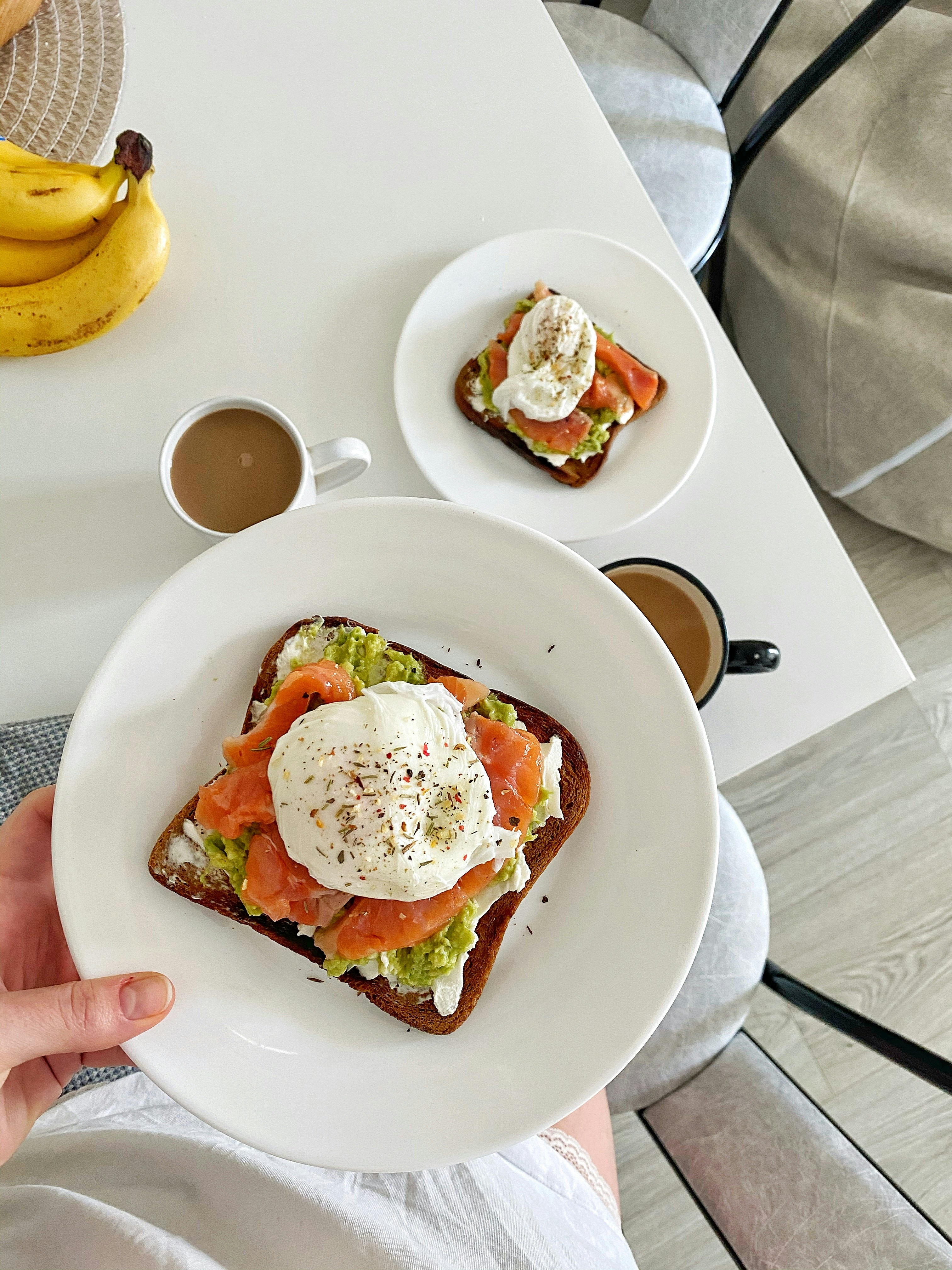 person holding white ceramic plate with food