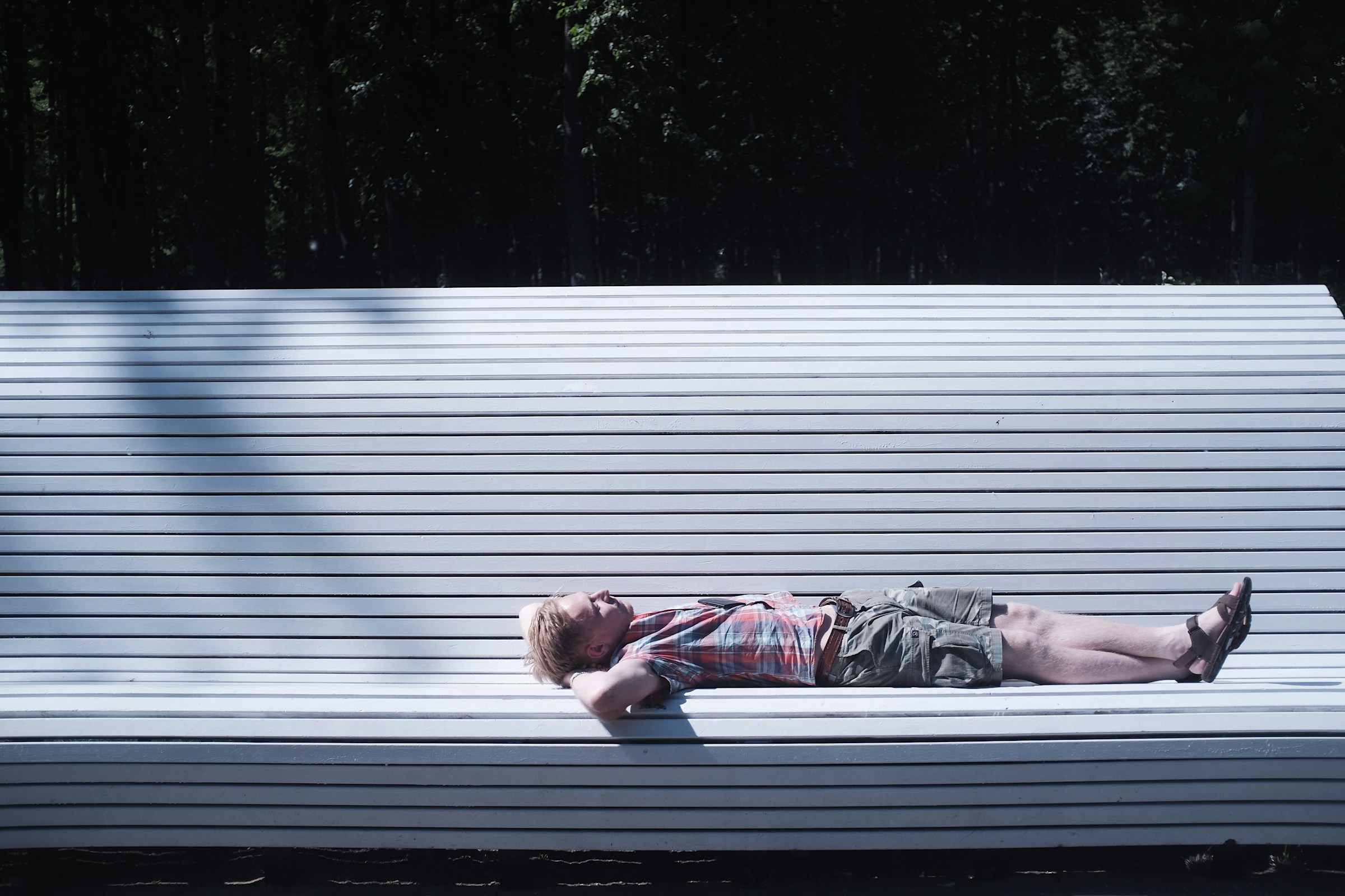 man sleeping on bench - Does Vitamin D from the Sun Make You Sleepy