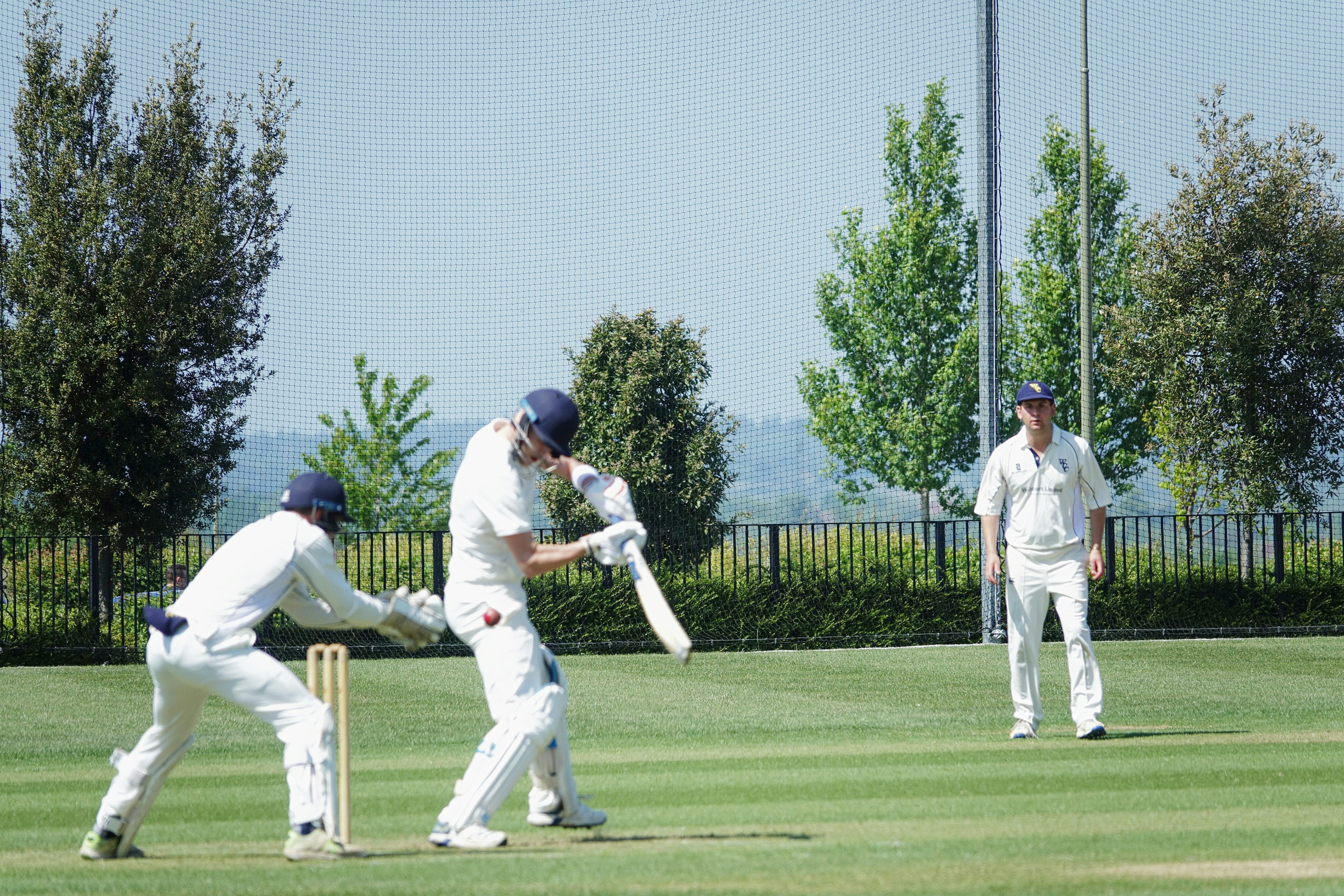 a group of men playing a game of cricket