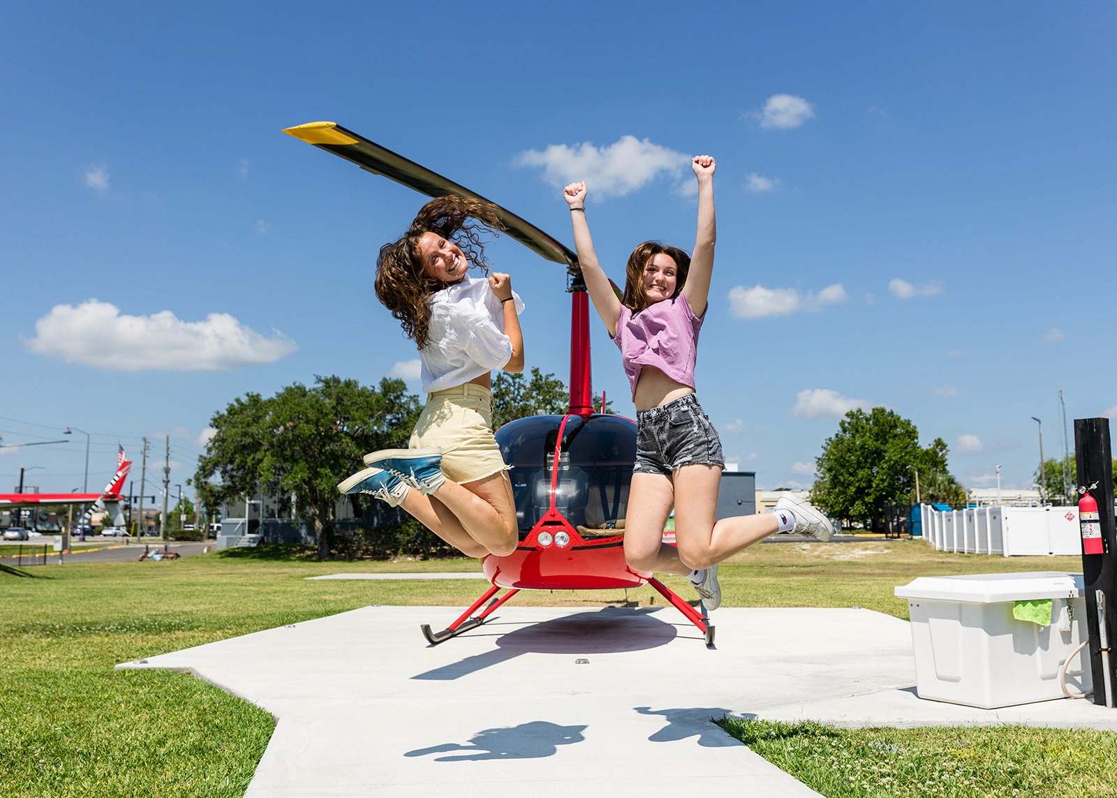 Girls jumping in front of helicopter