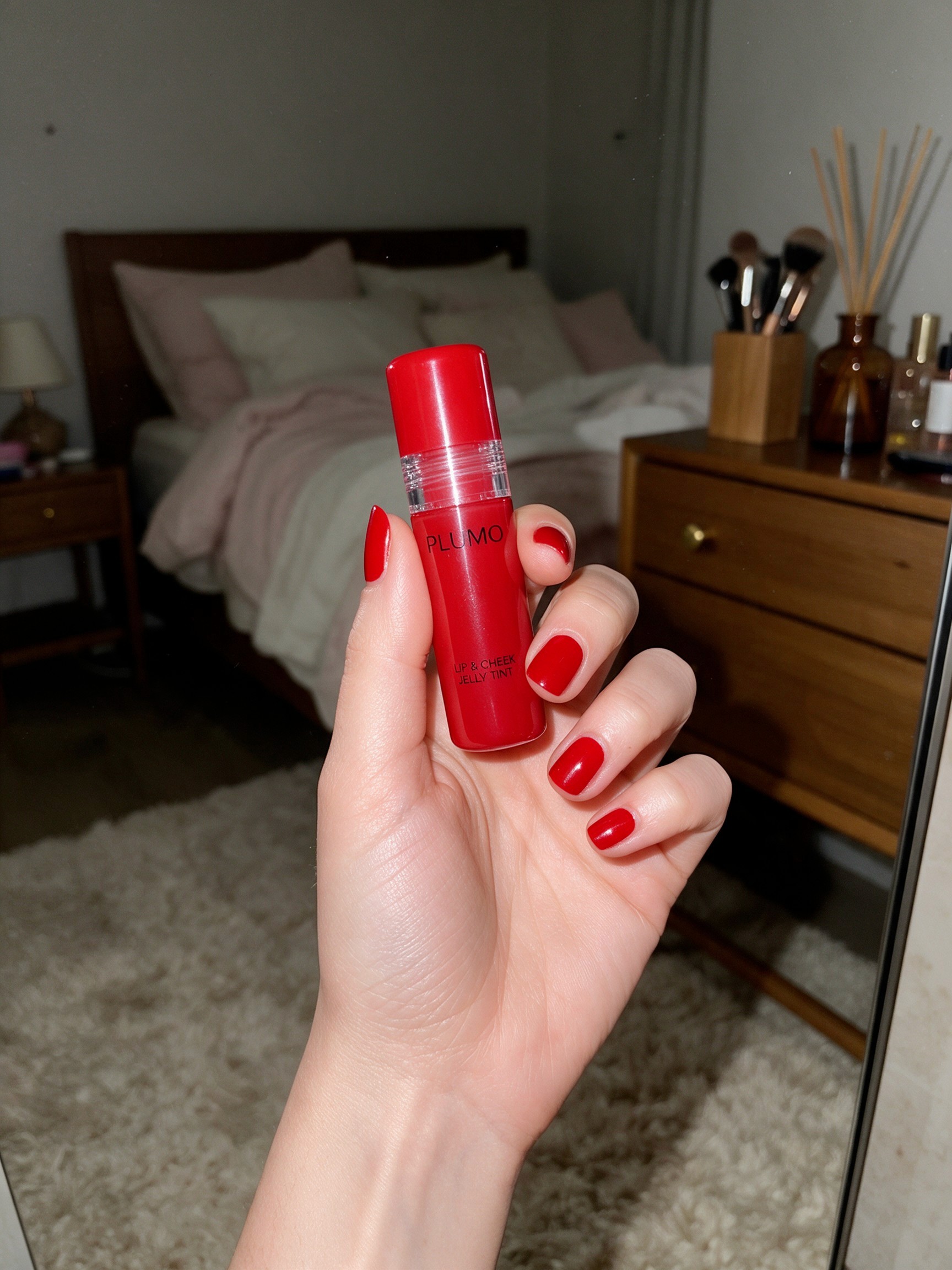 Customer holding a Jelly Tint tube with red nails