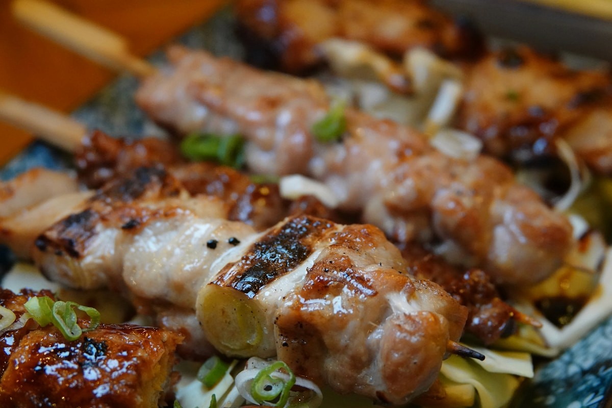 Grilled yakitori skewers served at an izakaya counter