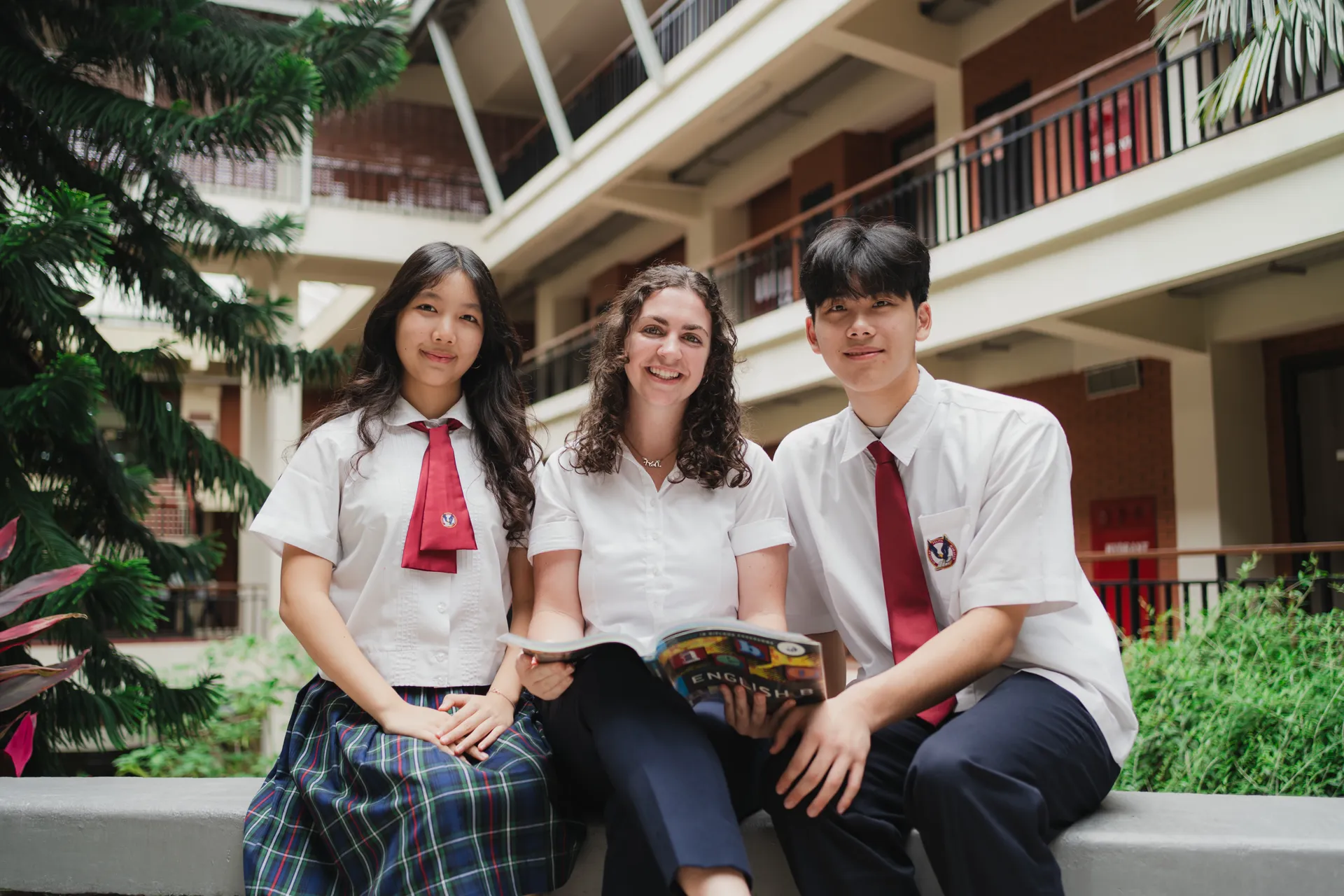 woman reading book while sitting on chair