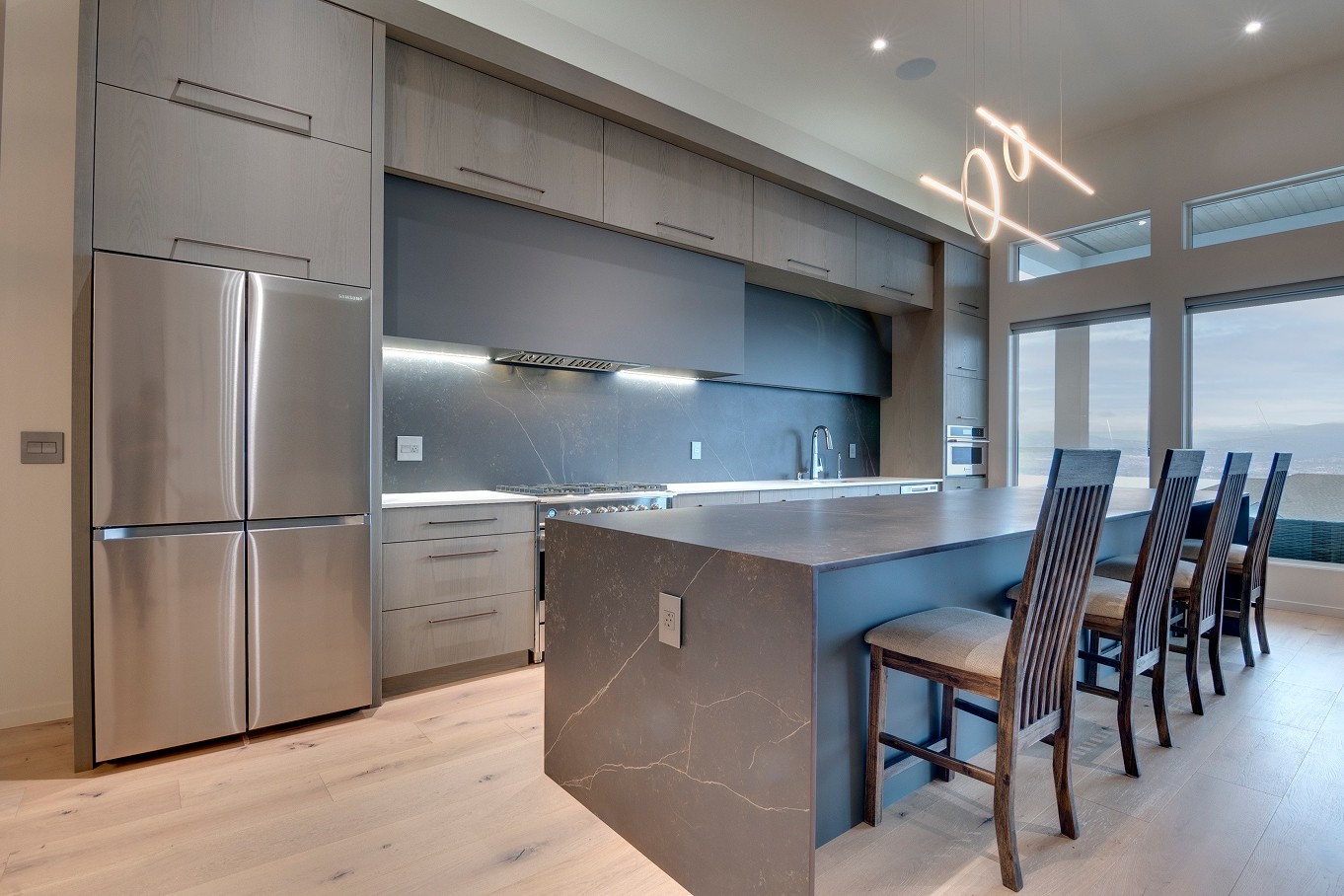 Spacious custom kitchen with matte cabinetry, large island, and seating