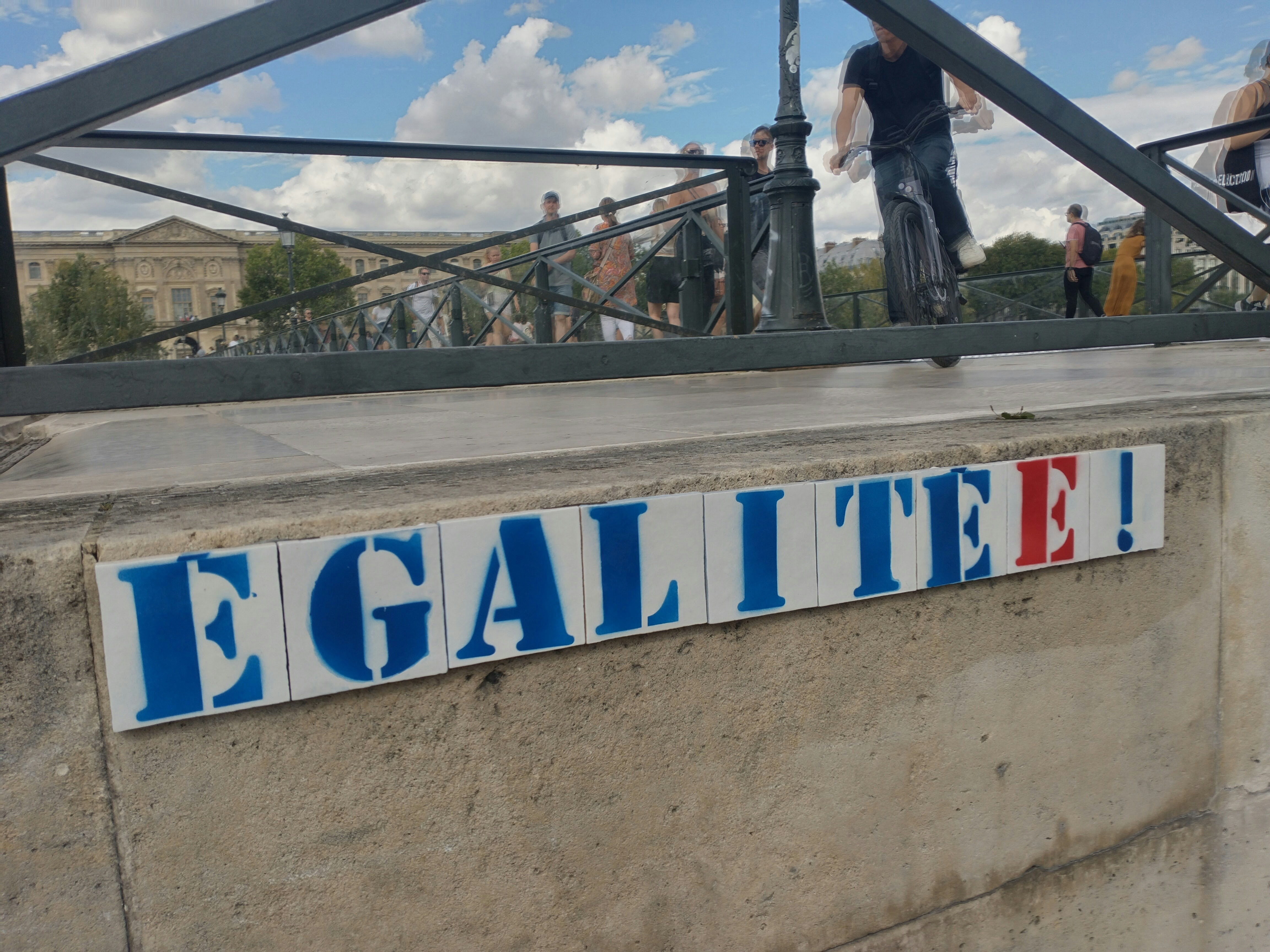 a group of people standing on a bridge