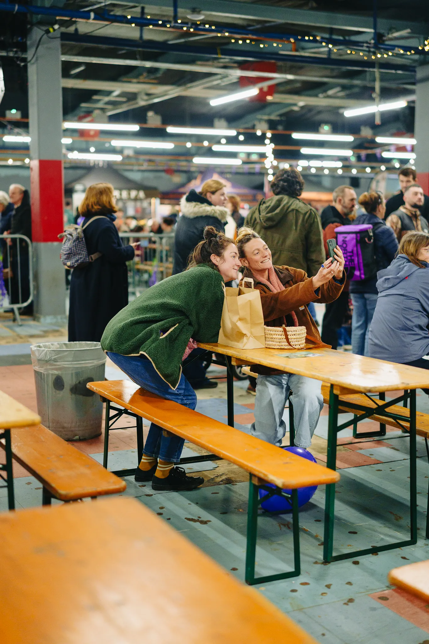 two women laughing whilst taking a selfie in sit down area at free from festival
