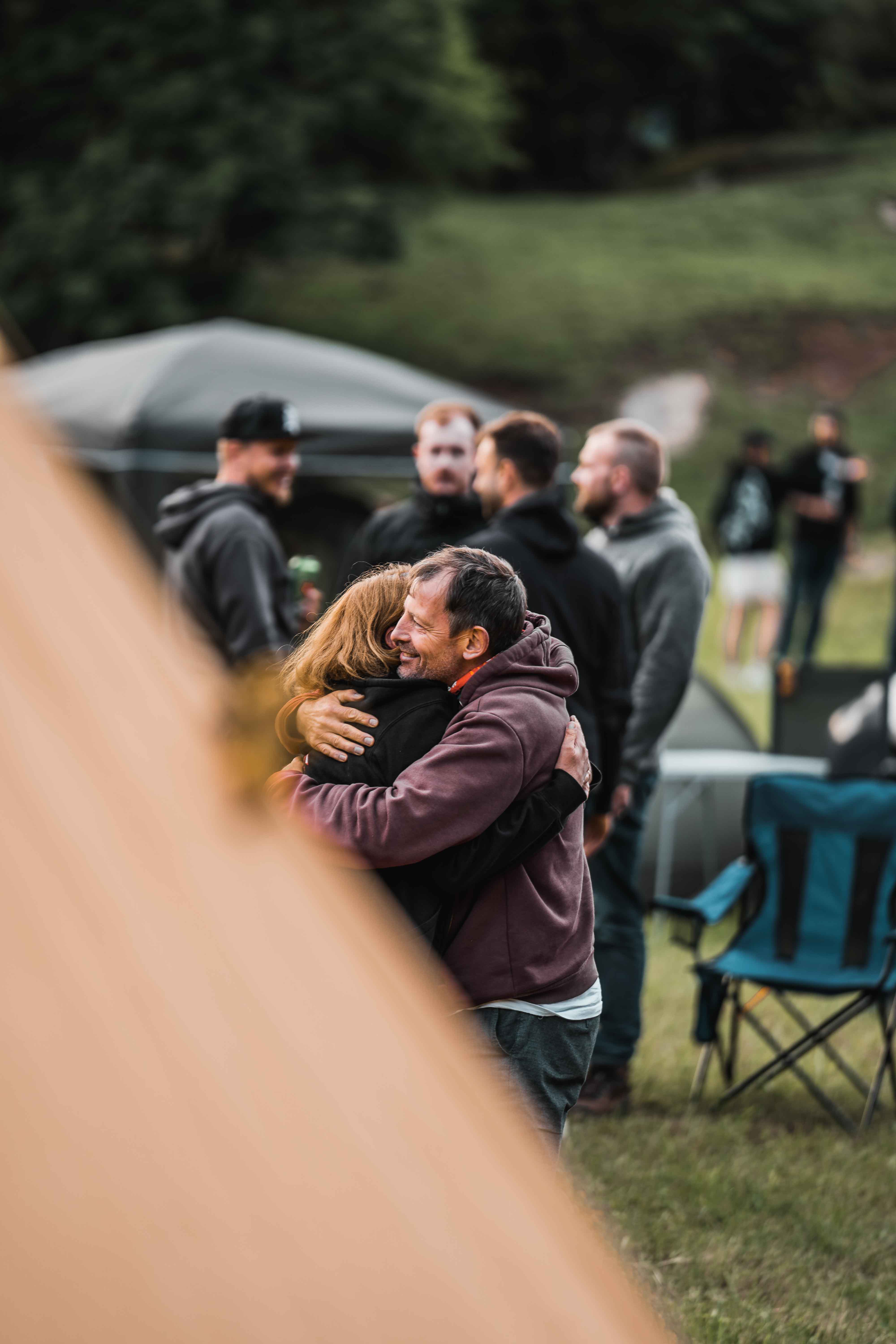 Traveler exploring narrow sandstone canyon illuminated by warm desert light in AlUla.