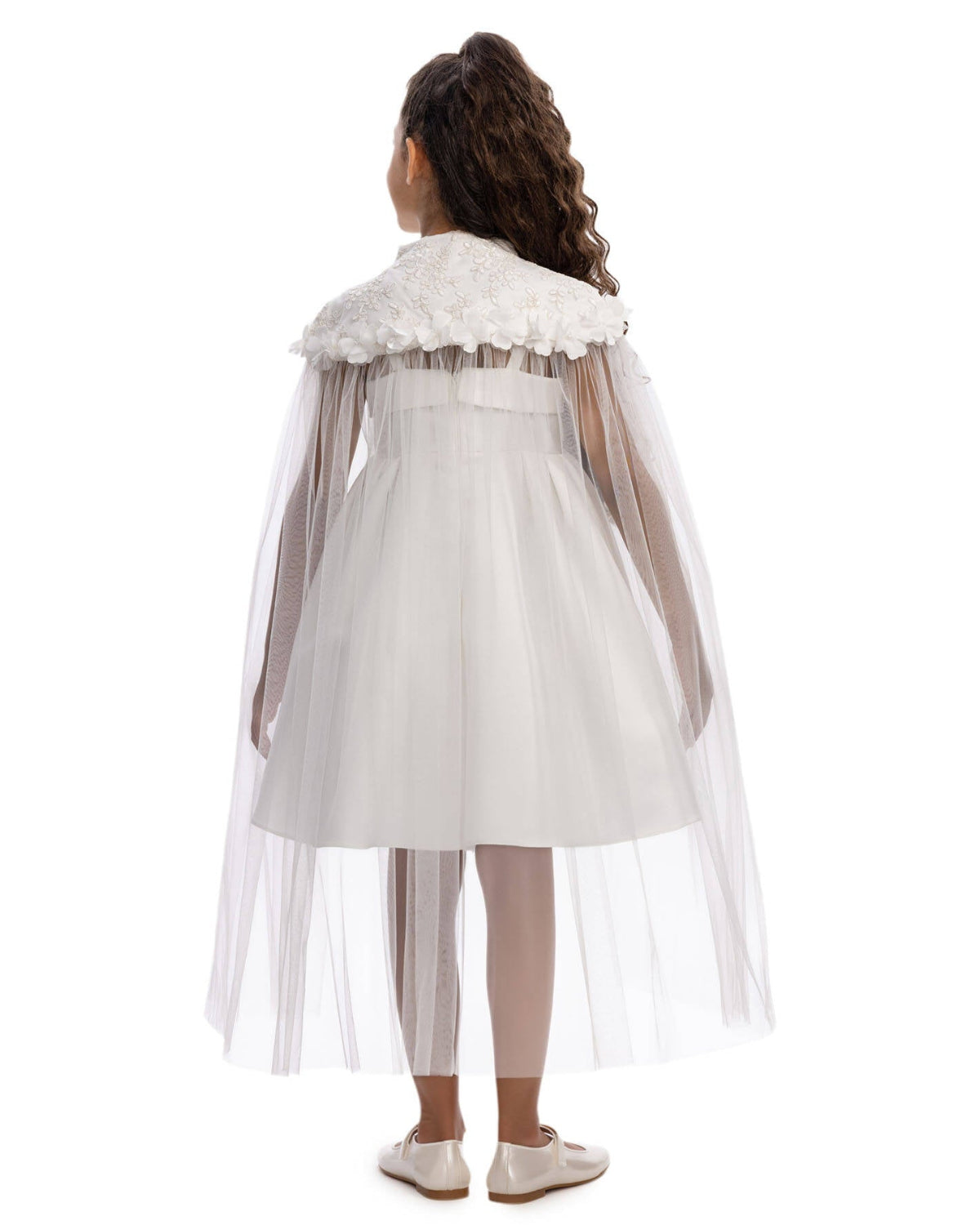 White dress with floral details and a sheer overlay on a white background