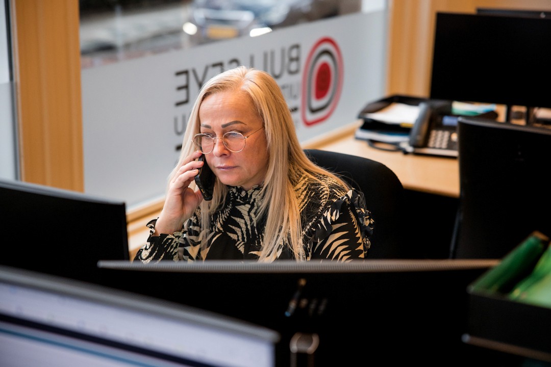 man in green and black plaid long sleeve shirt holding red and black cordless hand drill