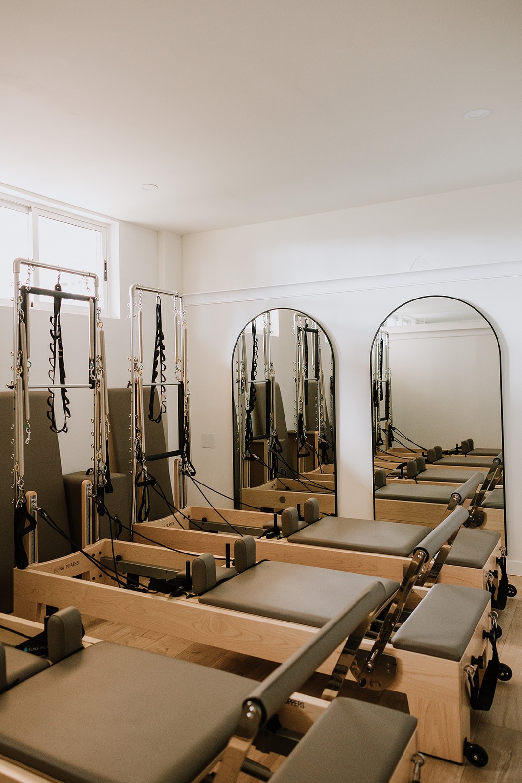 A serene spa setting with two lounge chairs beside a warm, reflective pool and soft, natural lighting.