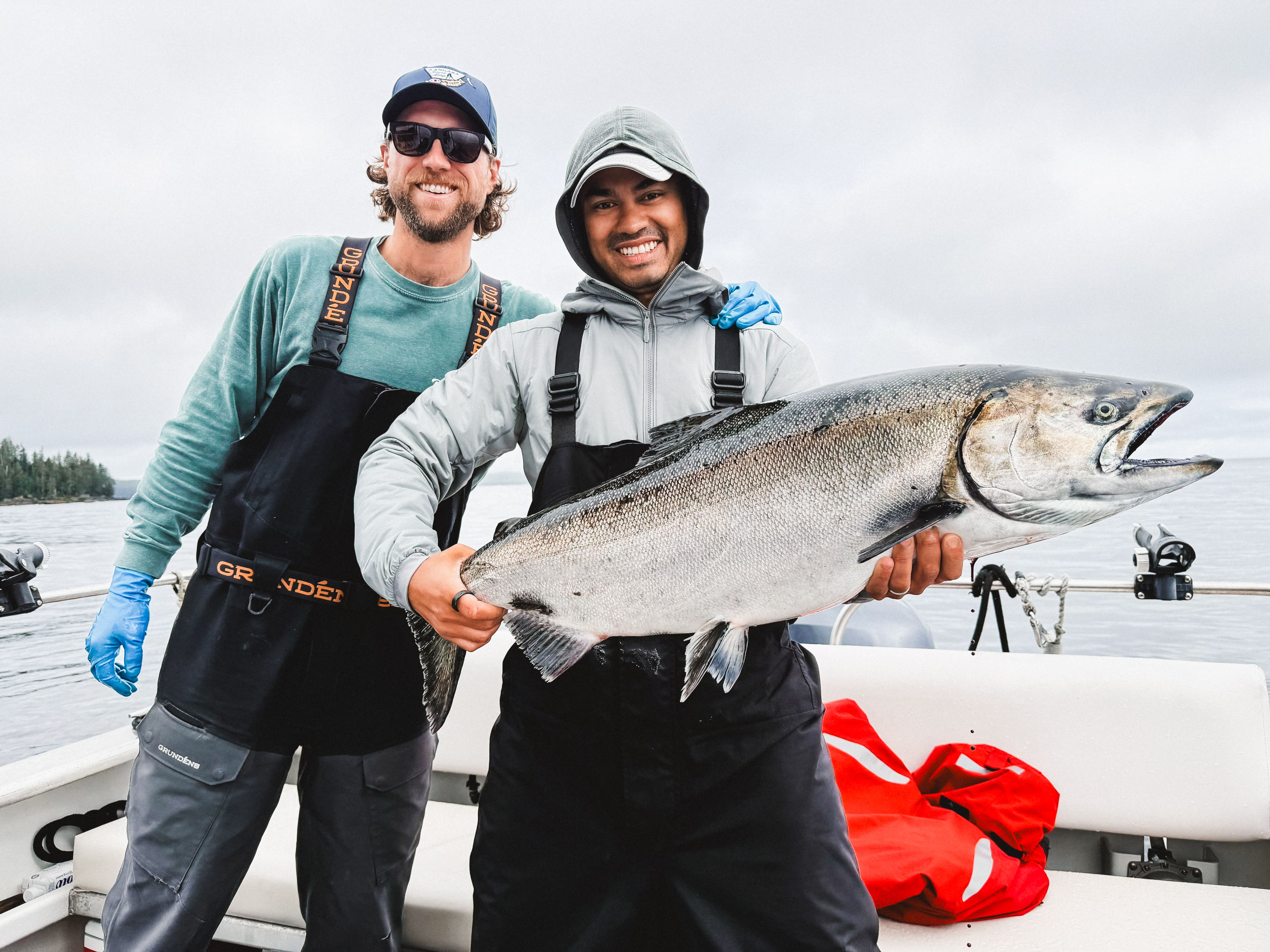 Full moon rising over a dark, silhouetted mountain ridge.