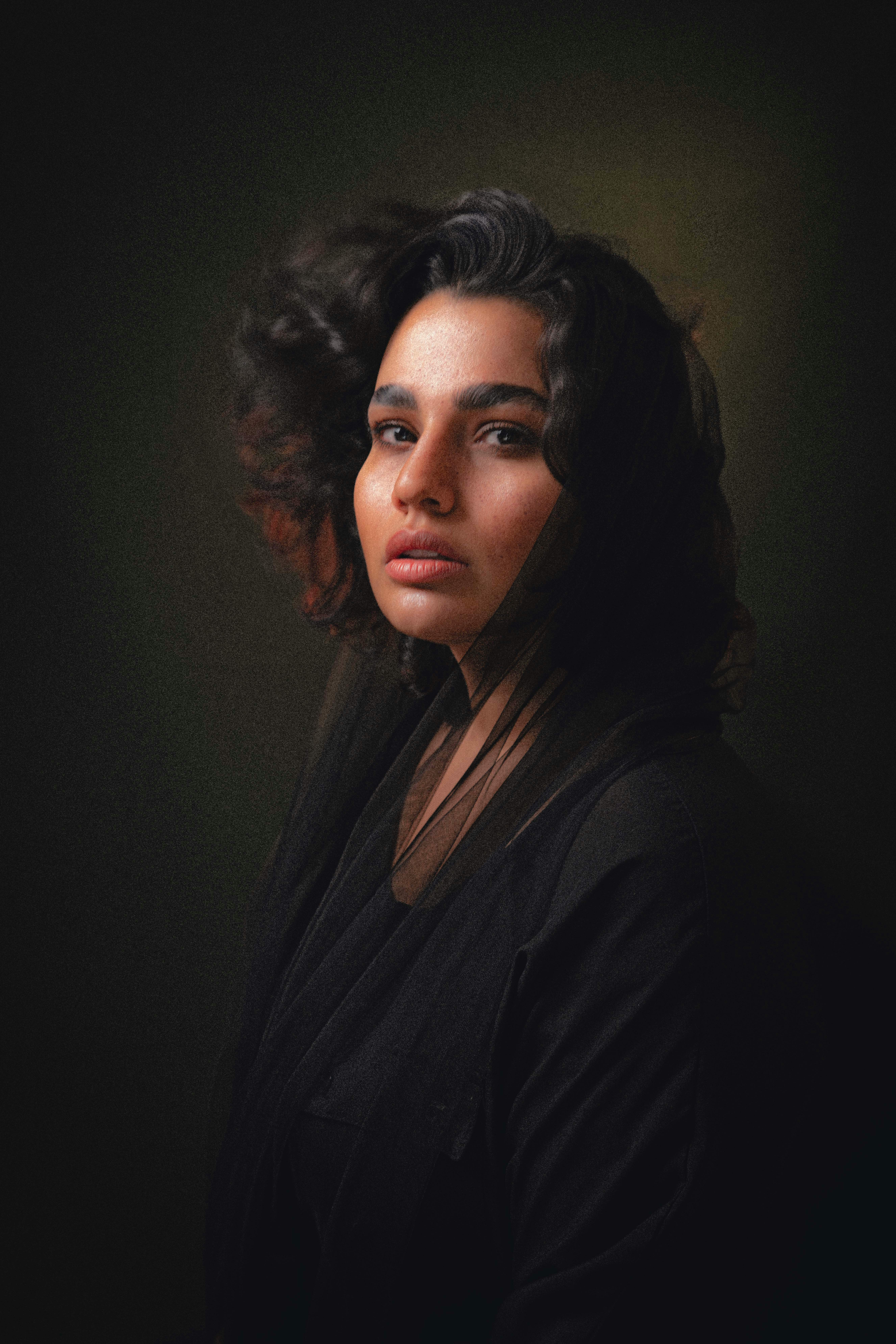 A woman with dark hair looking at the camera.