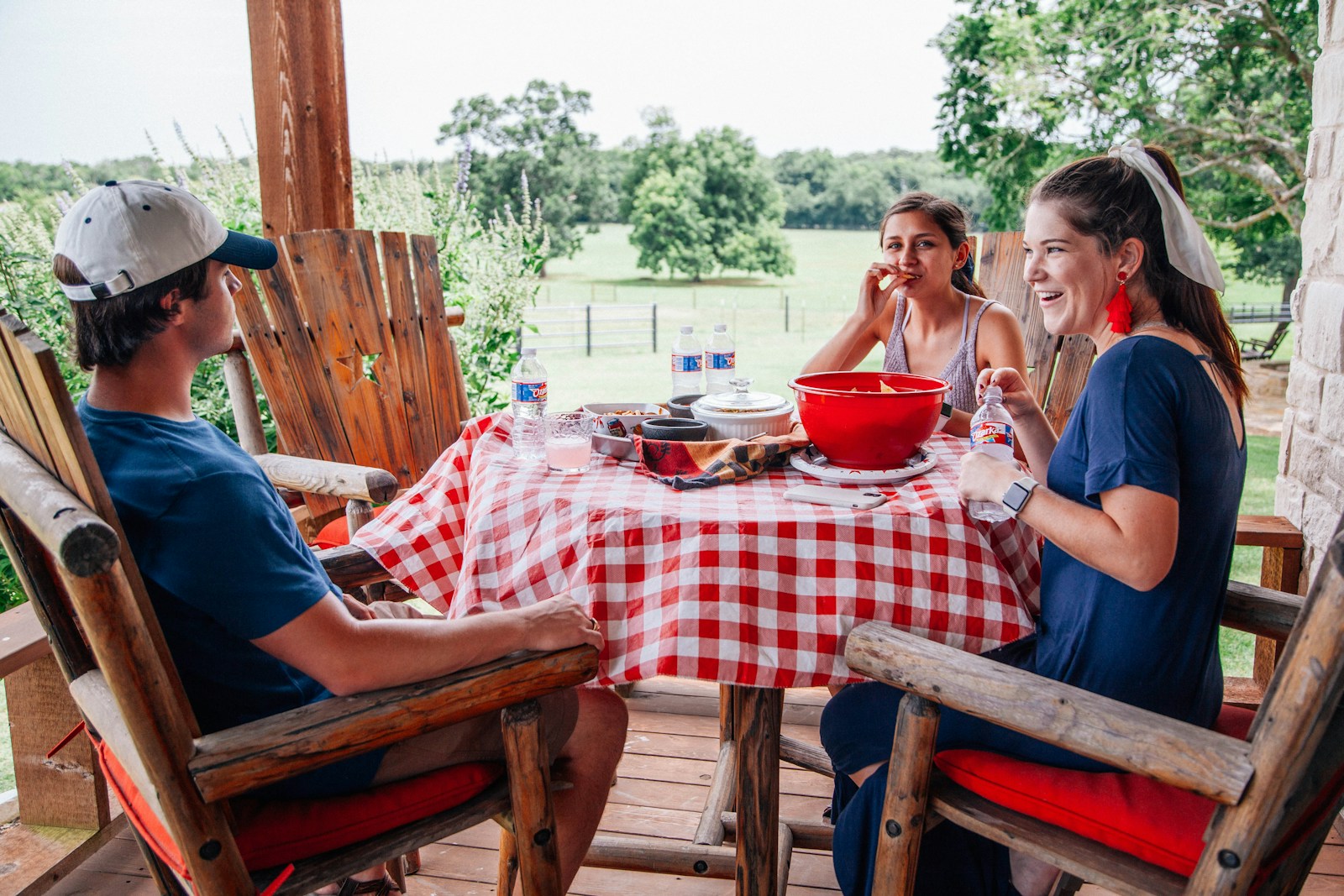 Friends sharing a relaxed lunch on a wooden porch
