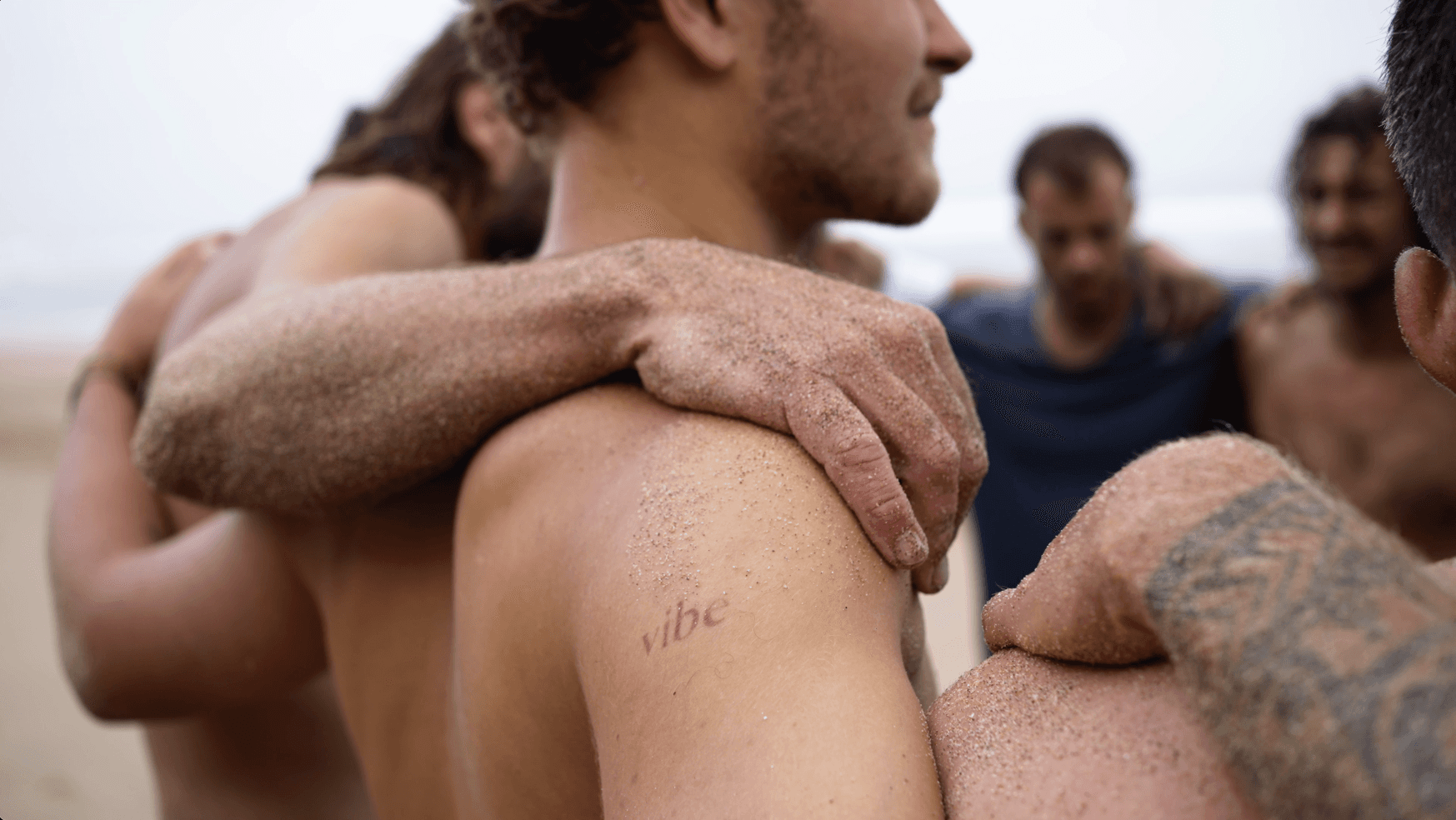 Vibe tattoo on shoulder on beach