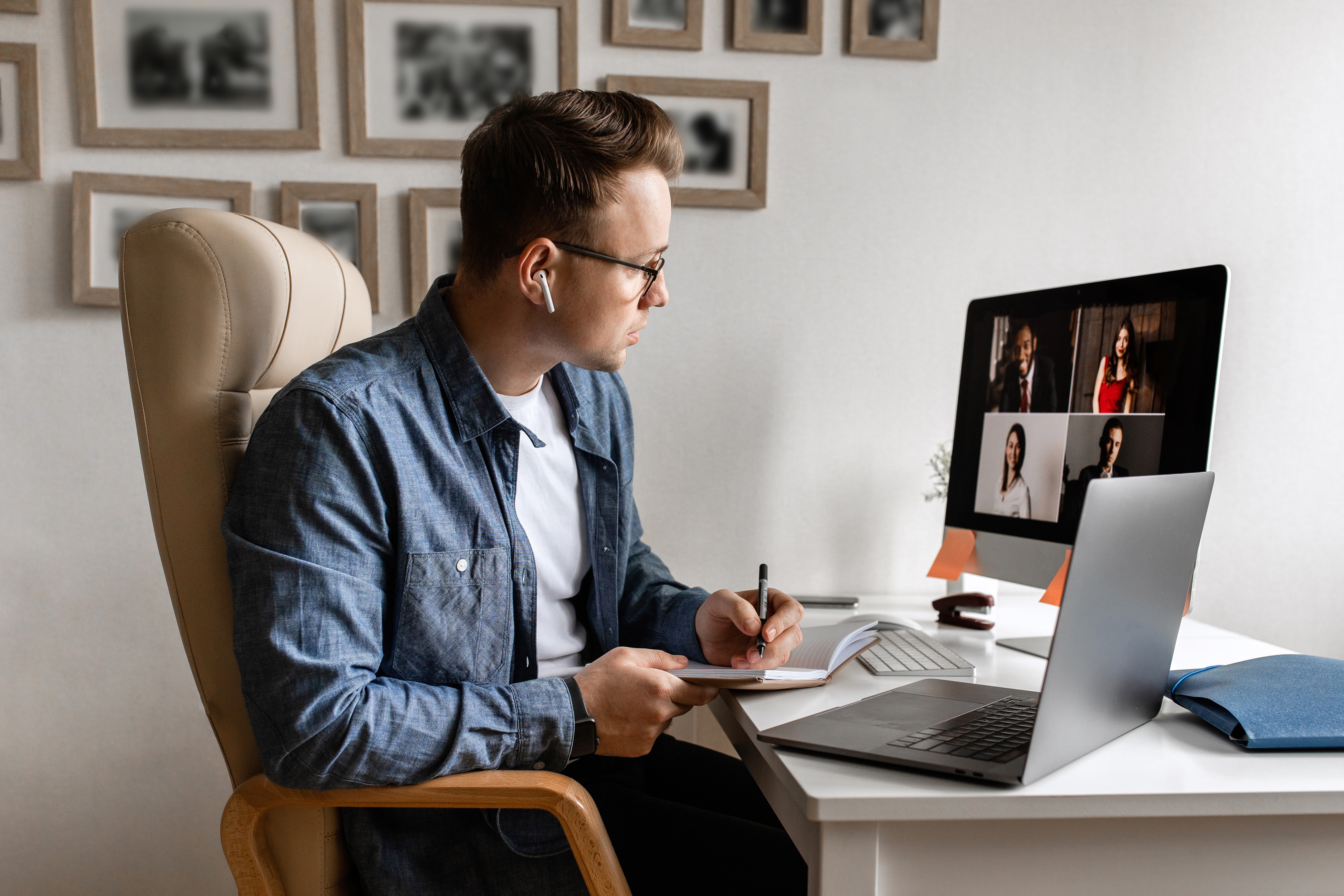 A man works at a desk with a computer on it.