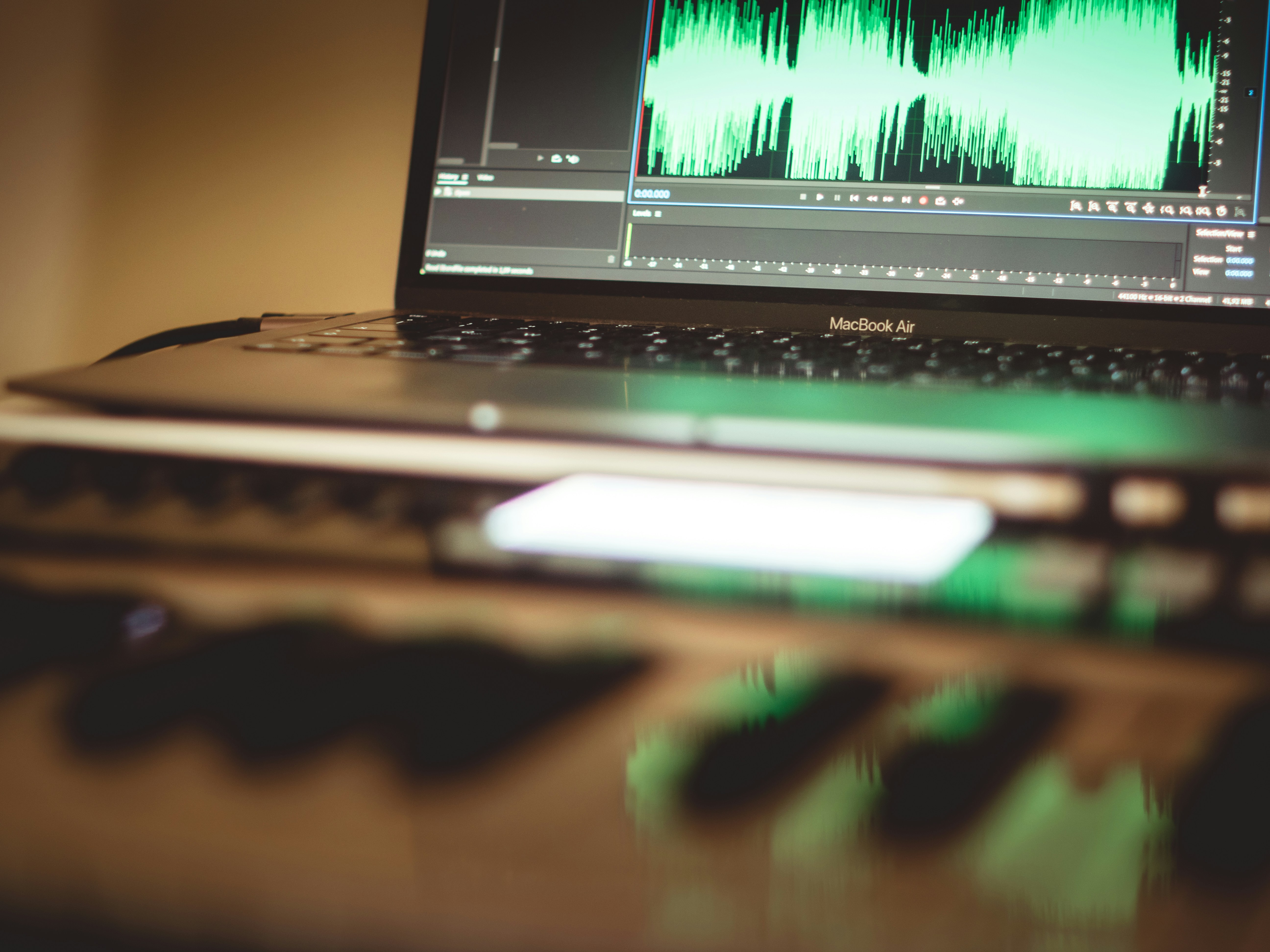 laptop and music production on adobe audition