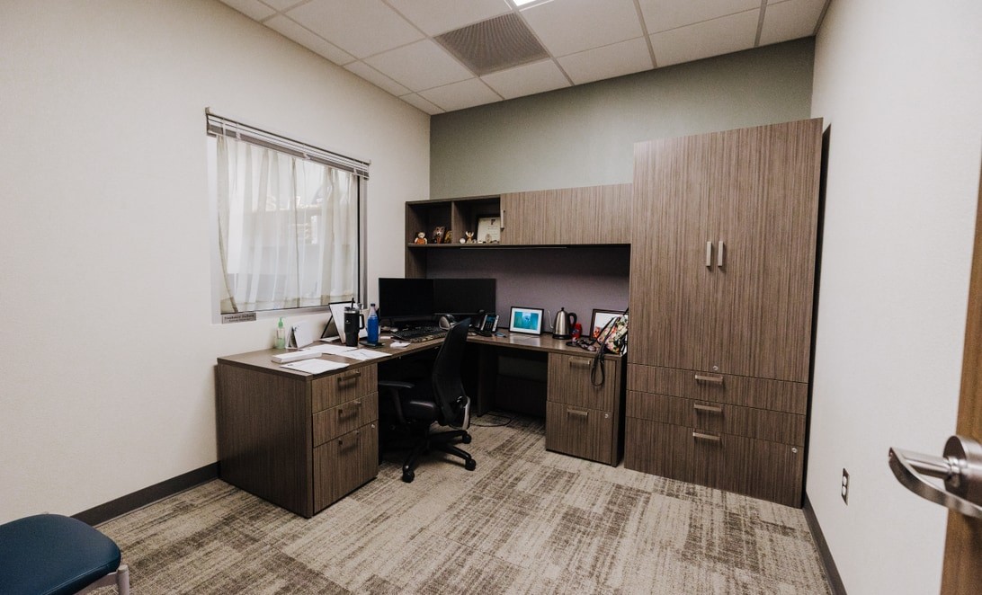 Admin office with built-in casework and storage at Plainview Police Headquarters, by Martinez Architects.