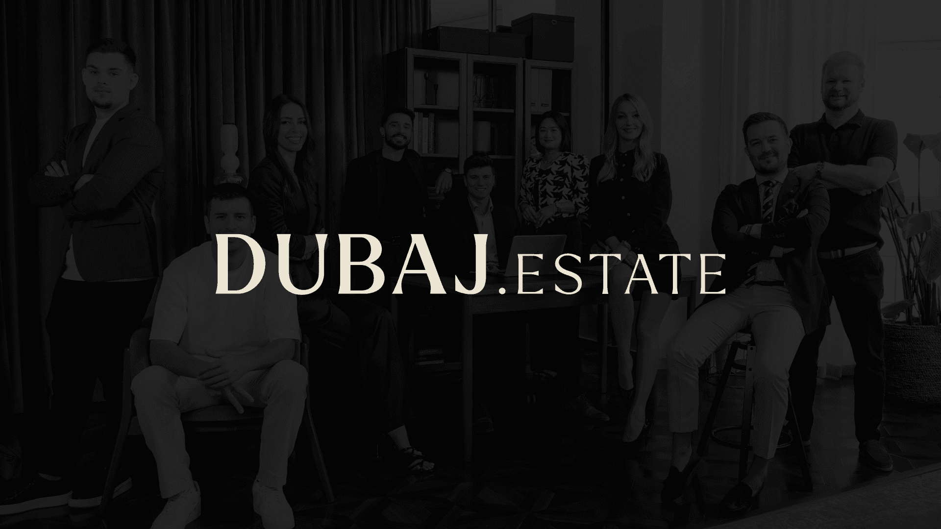 Portrait of a woman with curly hair wearing a two-tone gray and orange beanie against a neutral background.