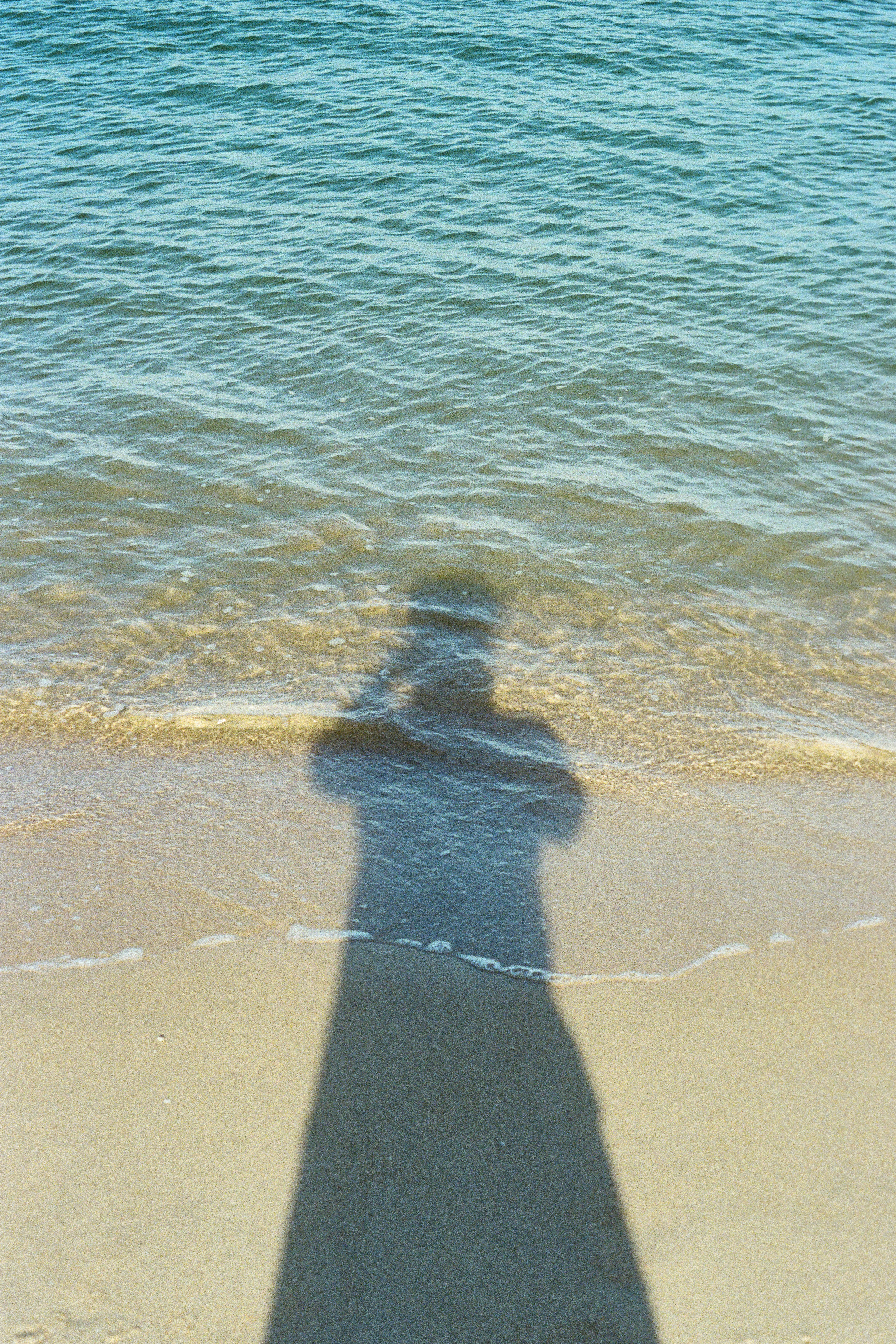 A shadow cast on the beach.