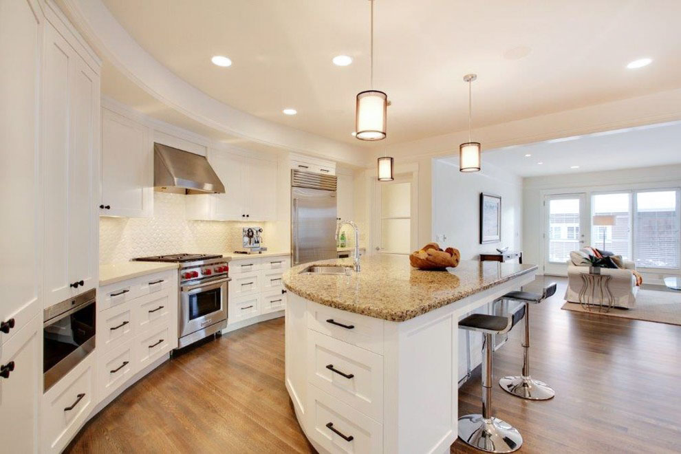 Image of KHD Homes kitchen design with island, granite countertops, and white cabinetry for luxury home renovations.