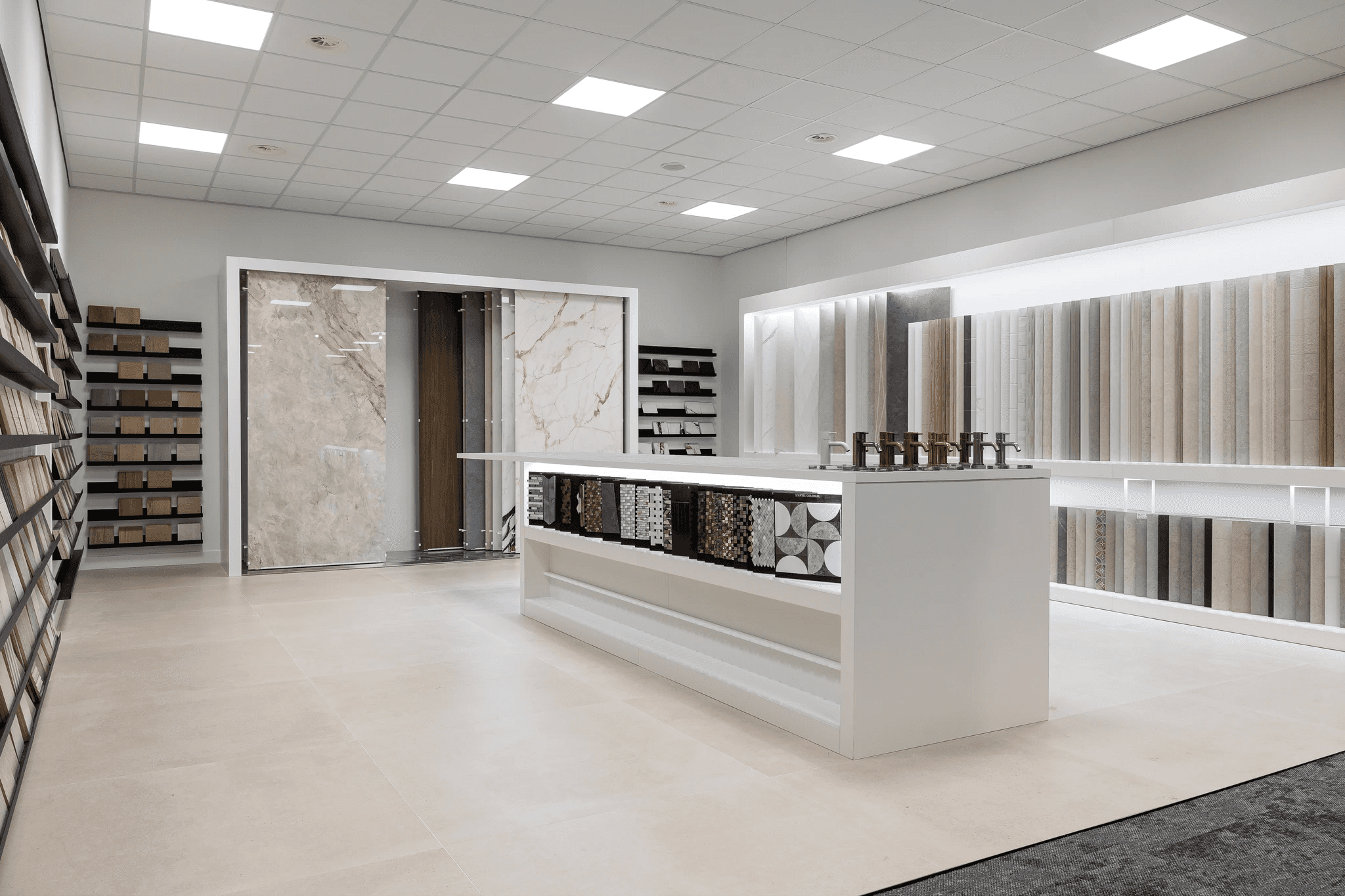 Three colleagues smiling and chatting together in a studio setting.