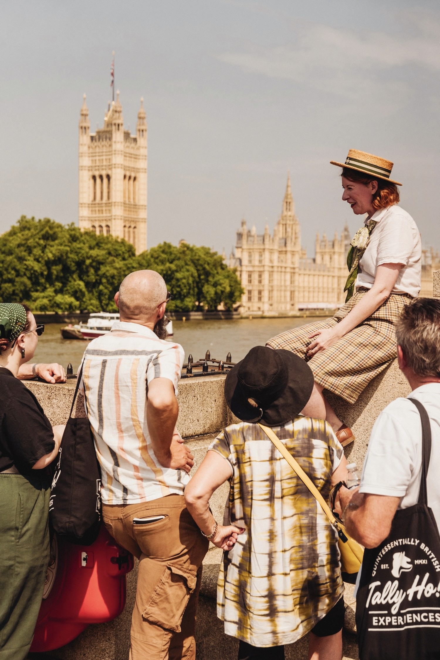 A Tally Ho tour guide stops on the River Thames in front of the House of Parliament