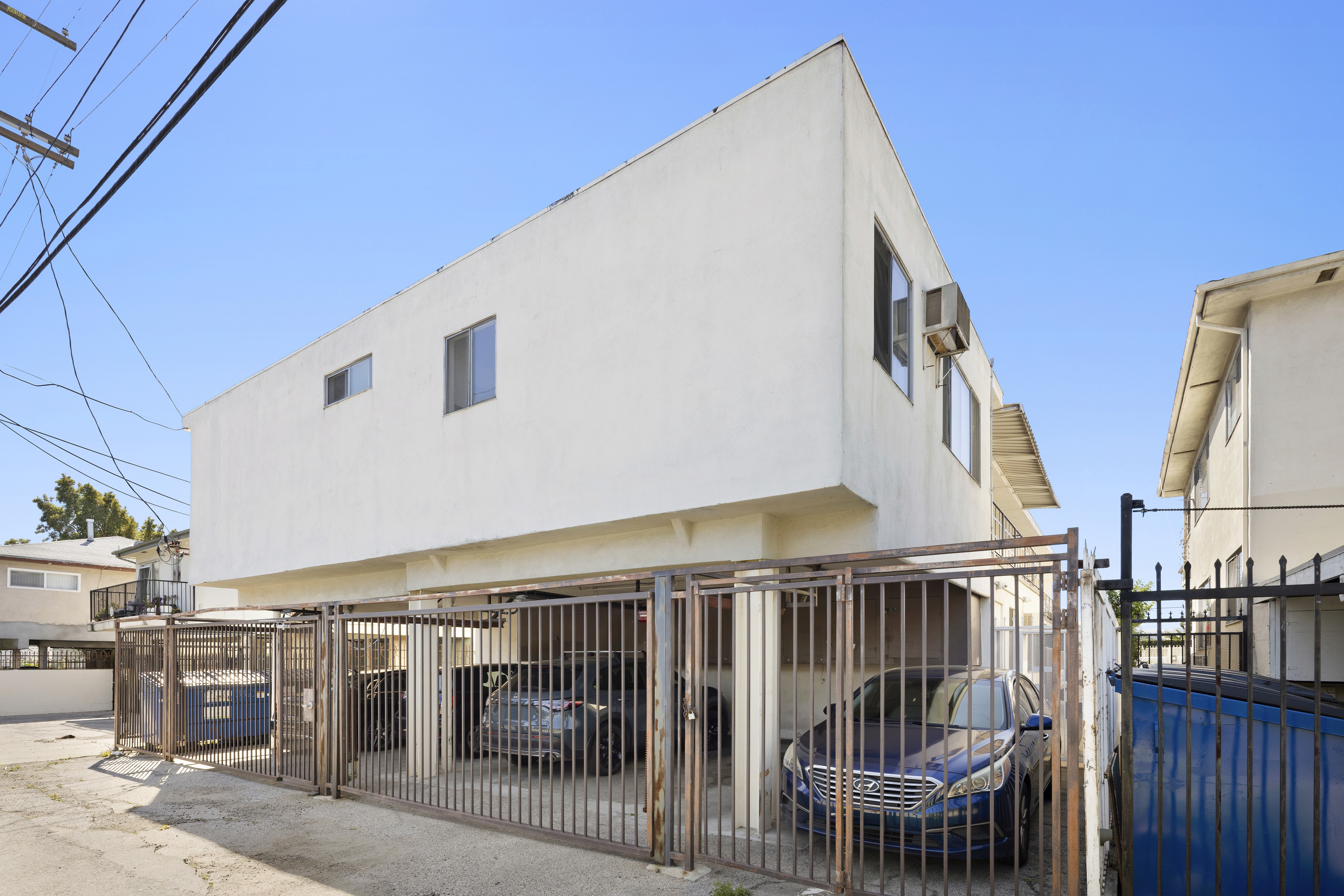 Rear parking area with gated access and covered spaces at multifamily property 1336 N Citrus Ave.