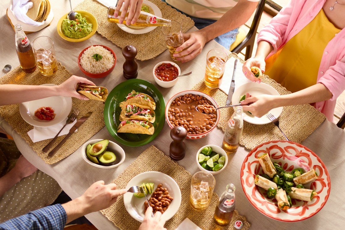 Friends sharing a spread of dishes at the dinner table