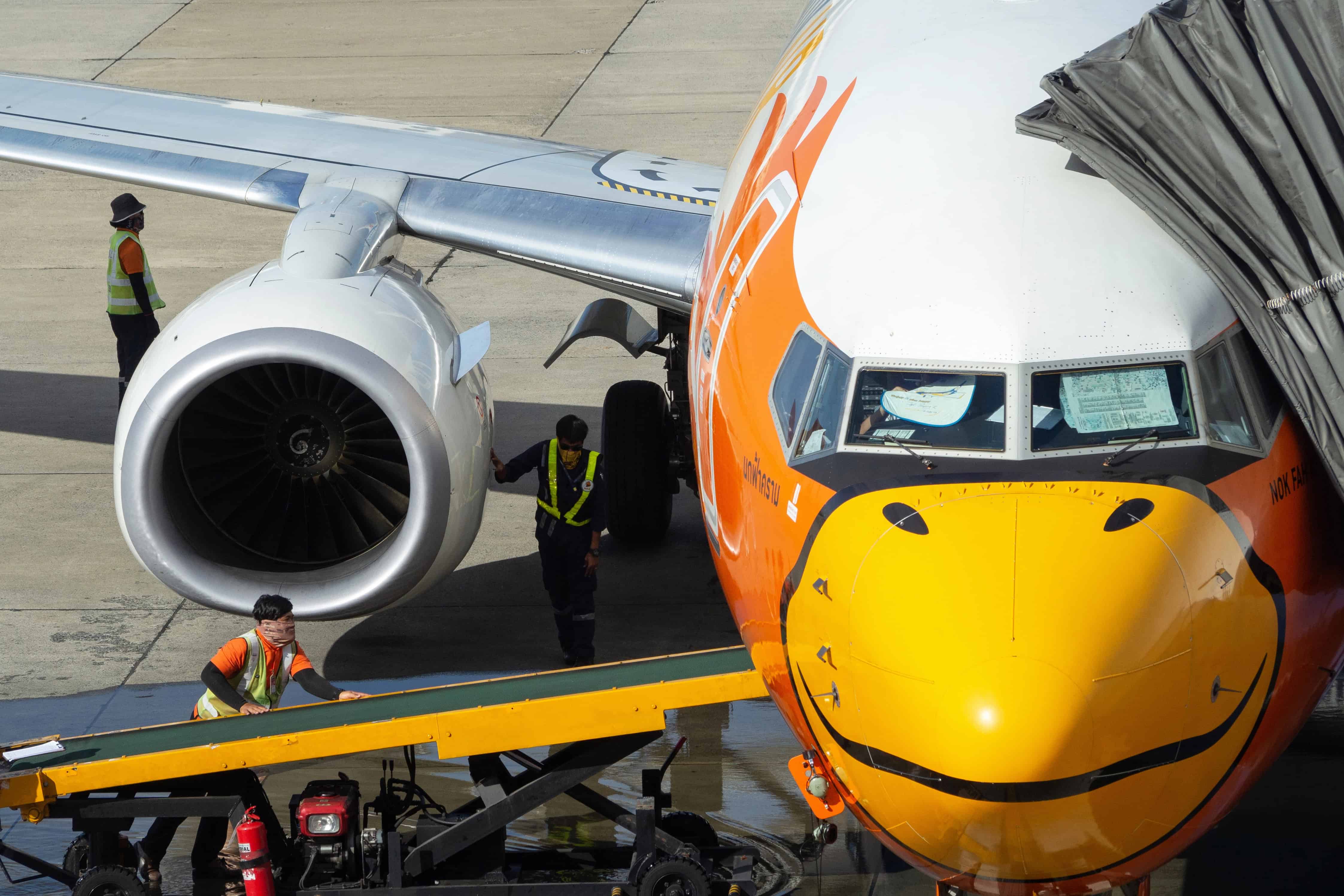 Ground transportation staff servicing an aircraft after landing