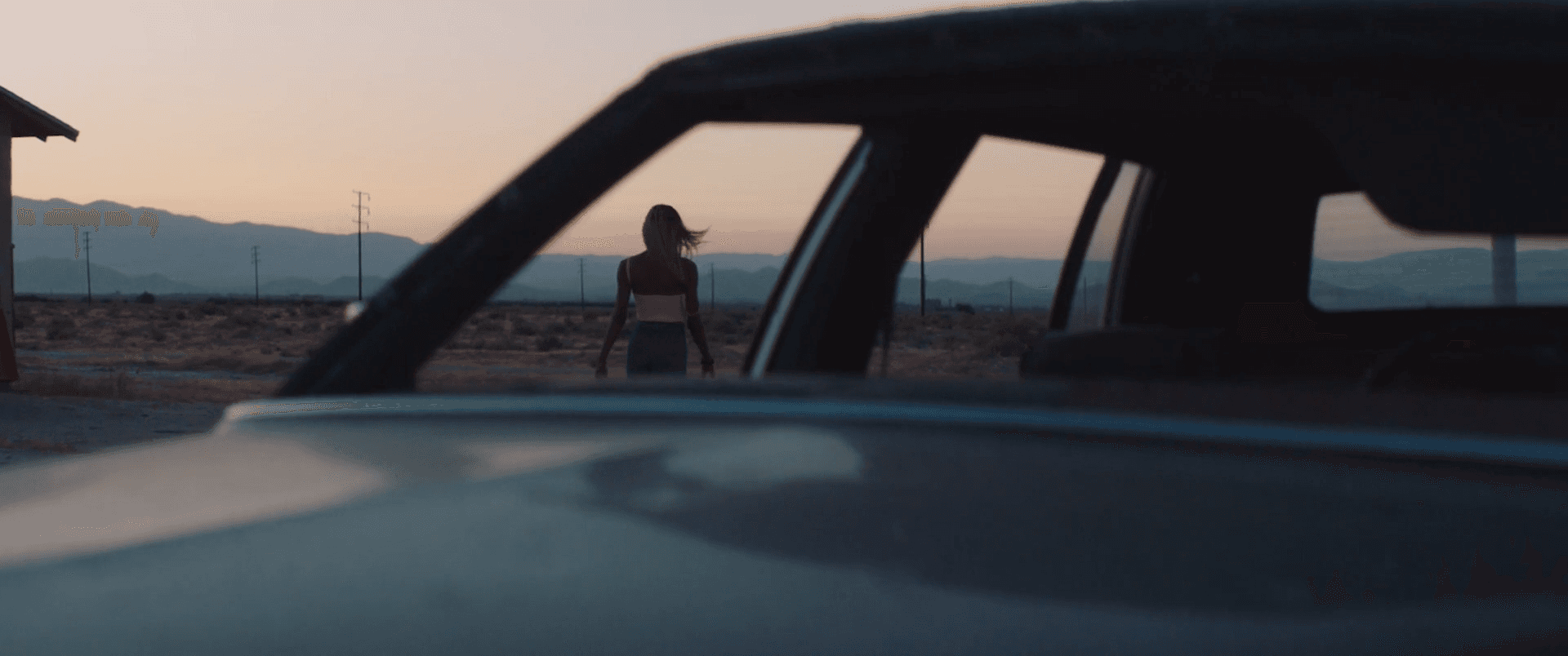 Two white houses nestled in a foggy, mountainous landscape.