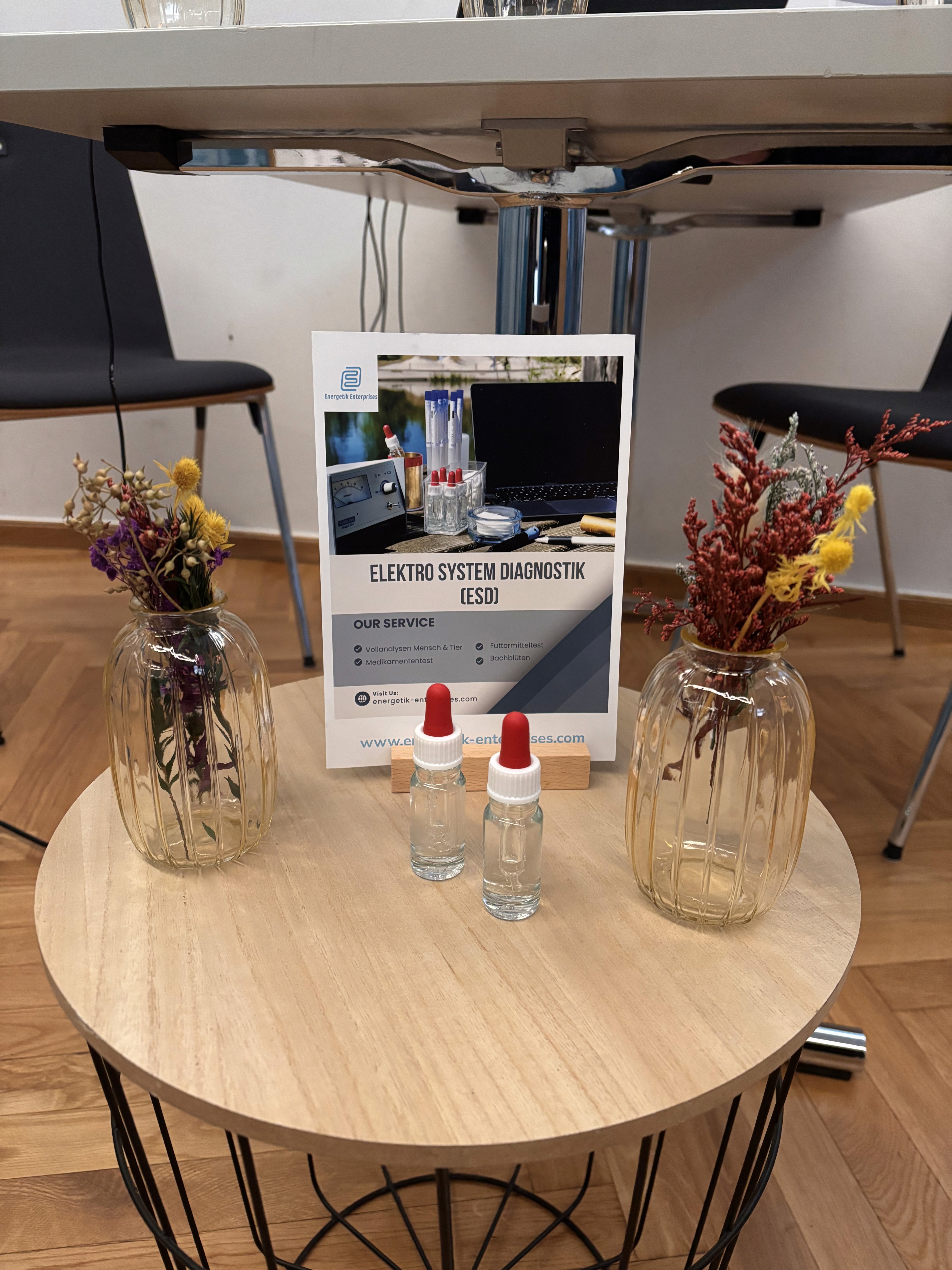 A woman lying on a massage bed, illuminated by soft sunlight streaming through a nearby window. A lush green plant in the background enhances the peaceful and rejuvenating ambiance.