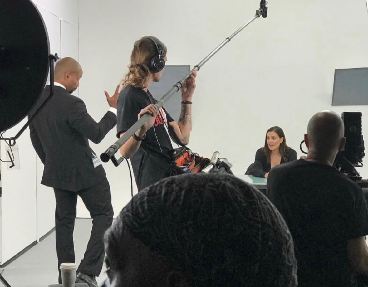 a woman holding a red flower