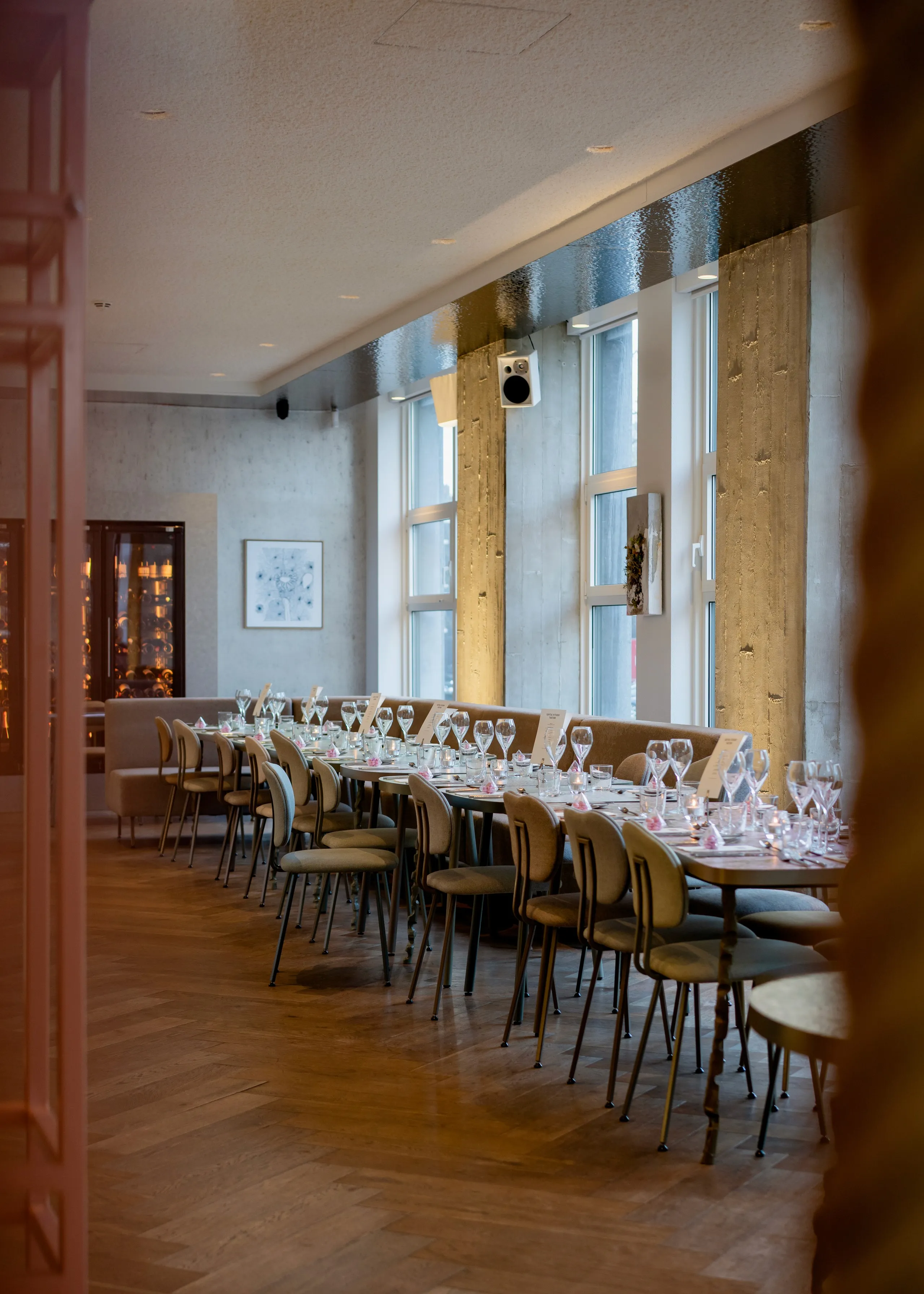 A spacious, well-lit room with a long table and chairs arranged neatly along the sides.