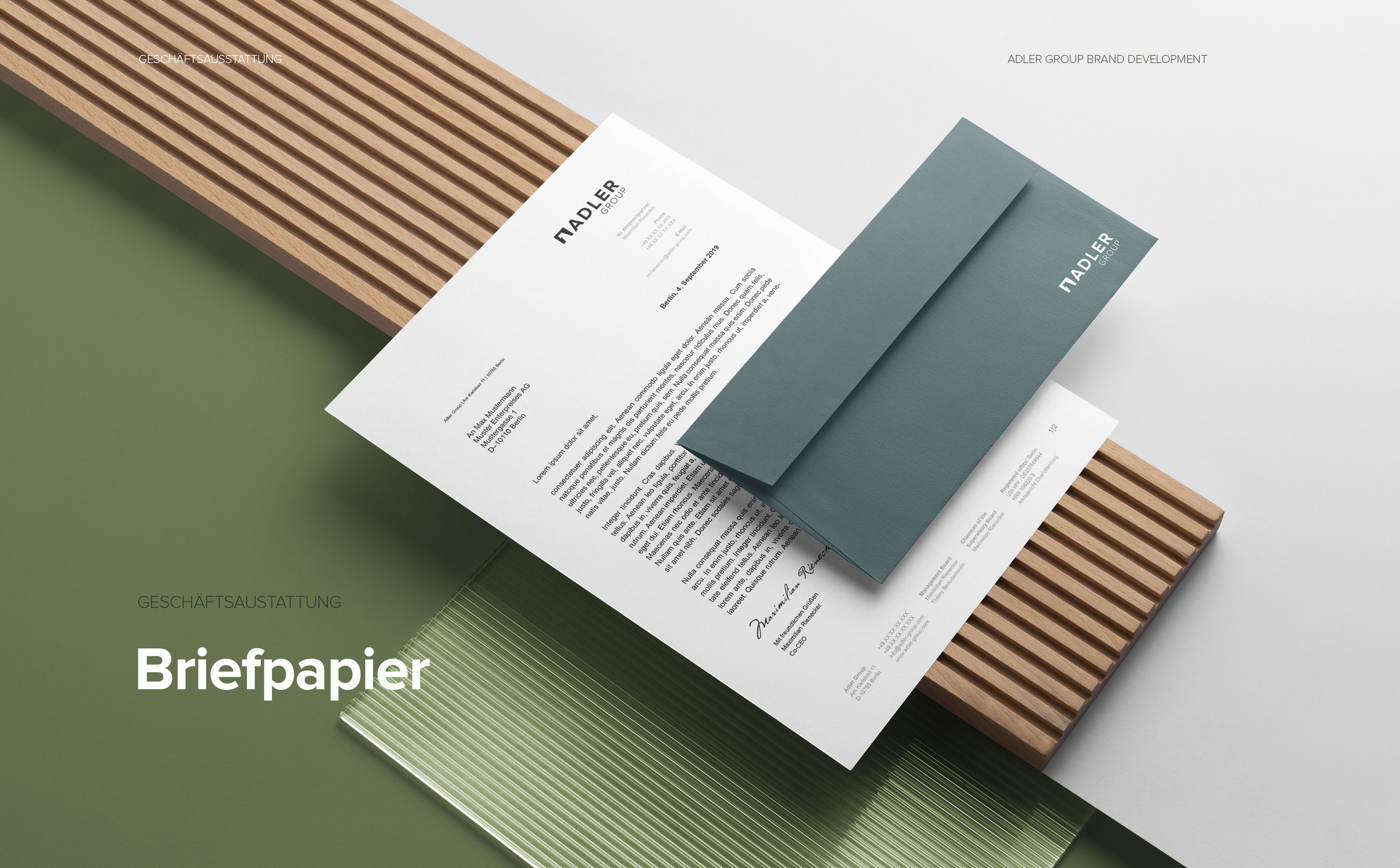 Geschäftsausstattung im Corporate Design der Adler Group – Briefpapier, Visitenkarten und Unternehmenskommunikation.