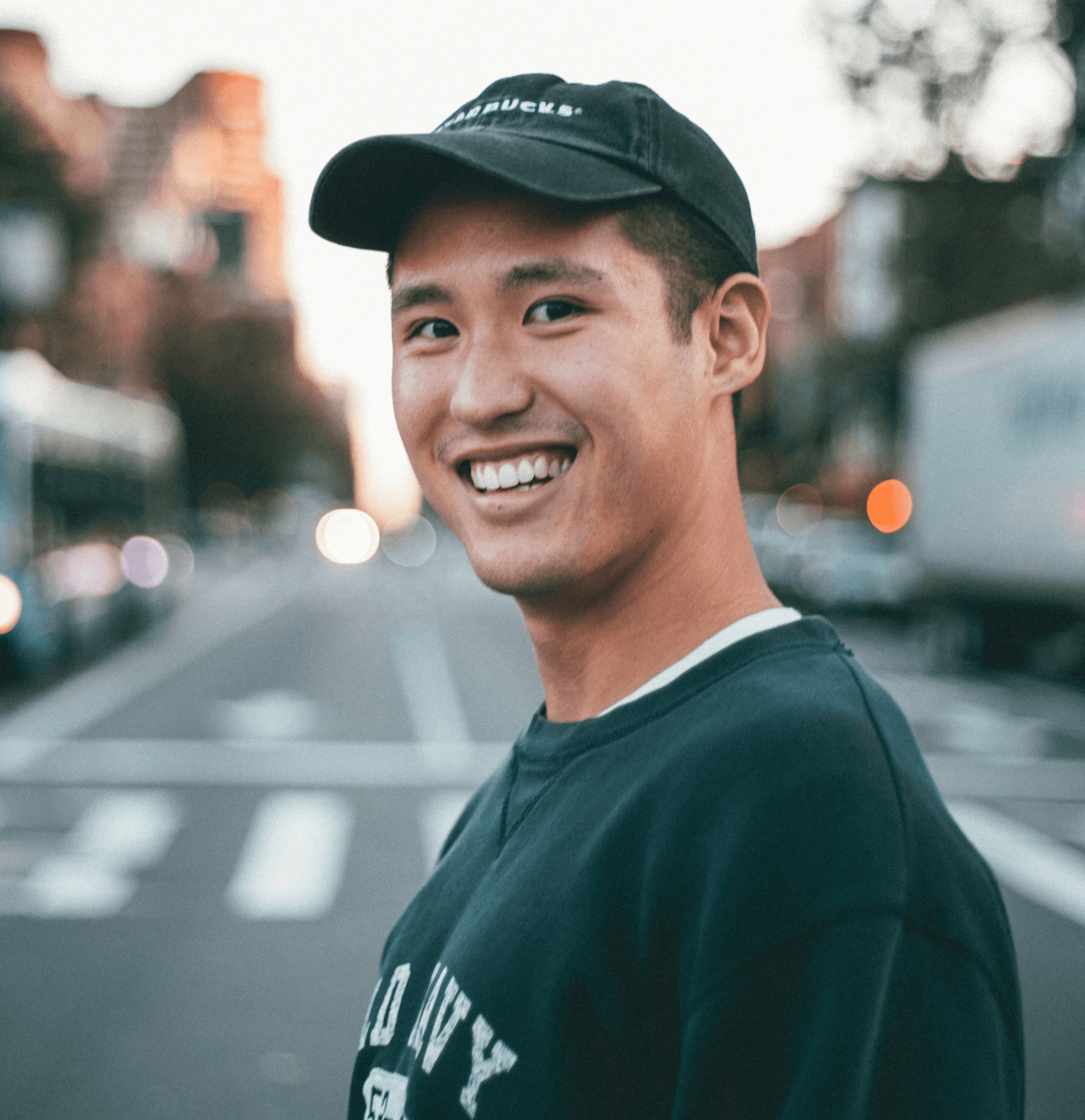 man stranding on straight road photo during daytime