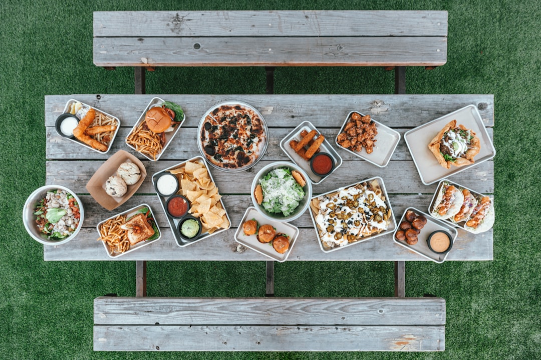 colorful 4th of July appetizer spread with dips, skewers, and fresh vegetables outdoors