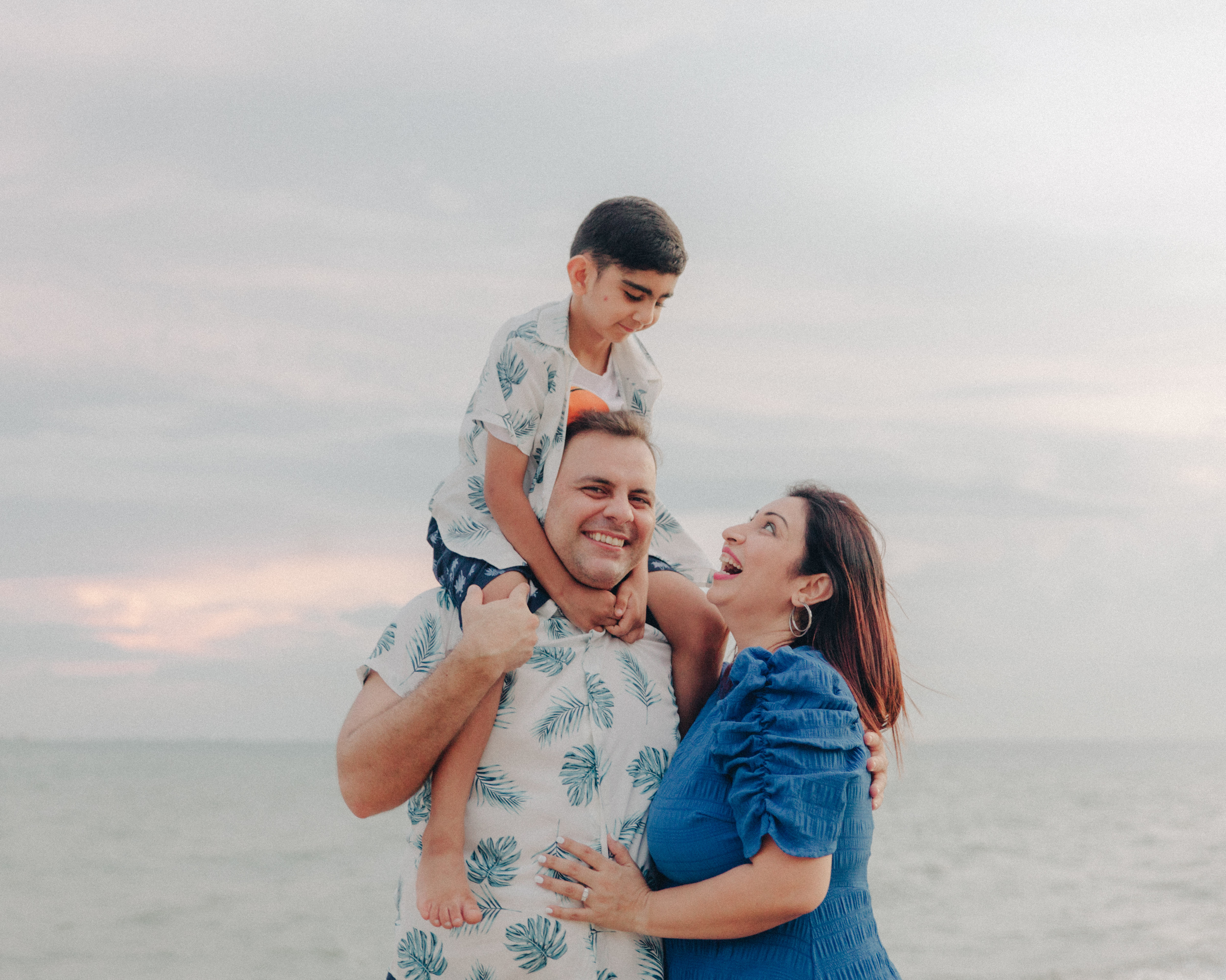Full color photo showcasing the soft, neutral color palette used in the family's wardrobe by the sea.