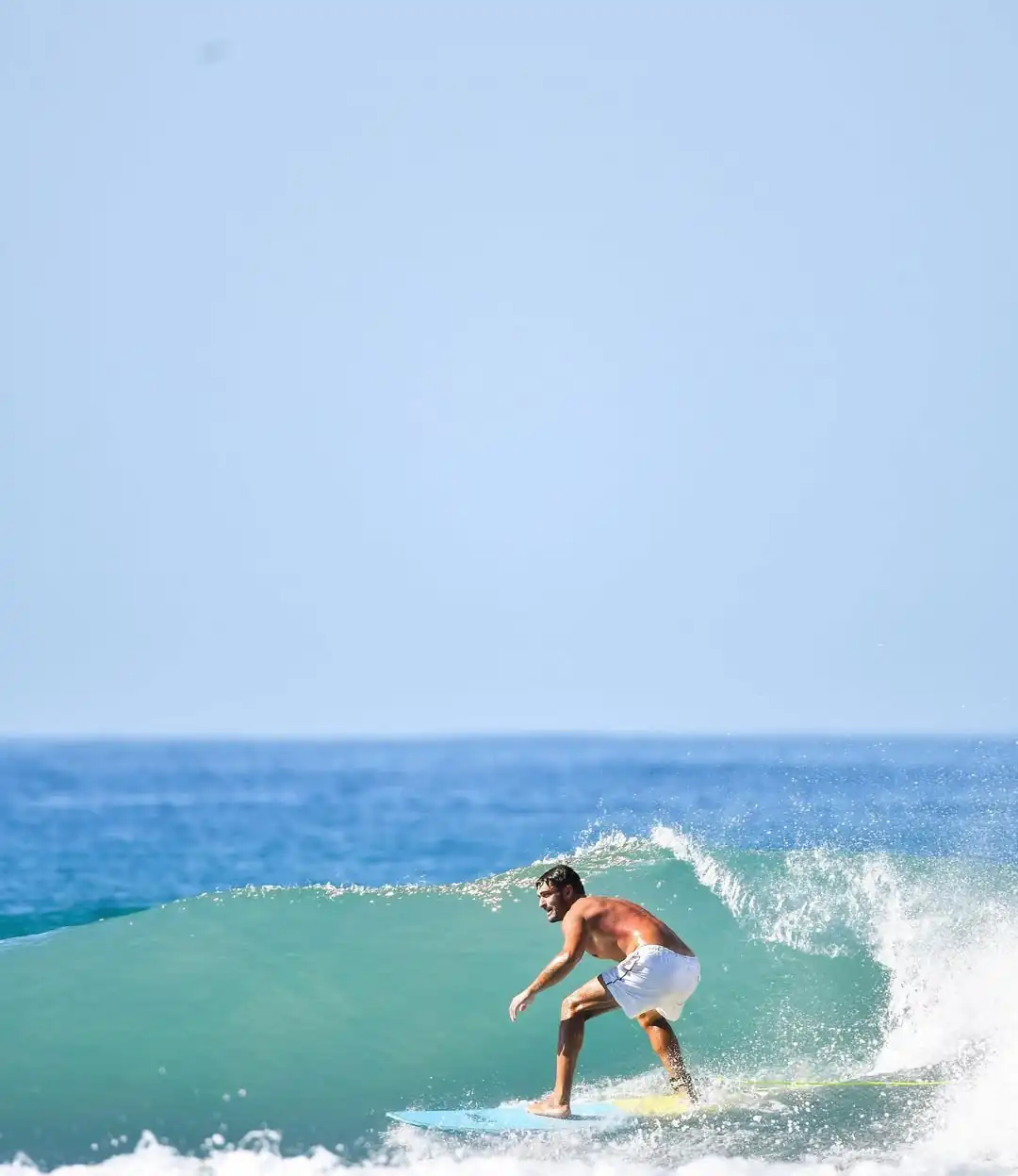 red train travelling near body of water