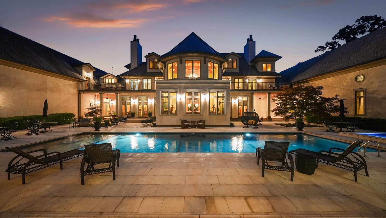Twilight courtyard with the turret over the pool
