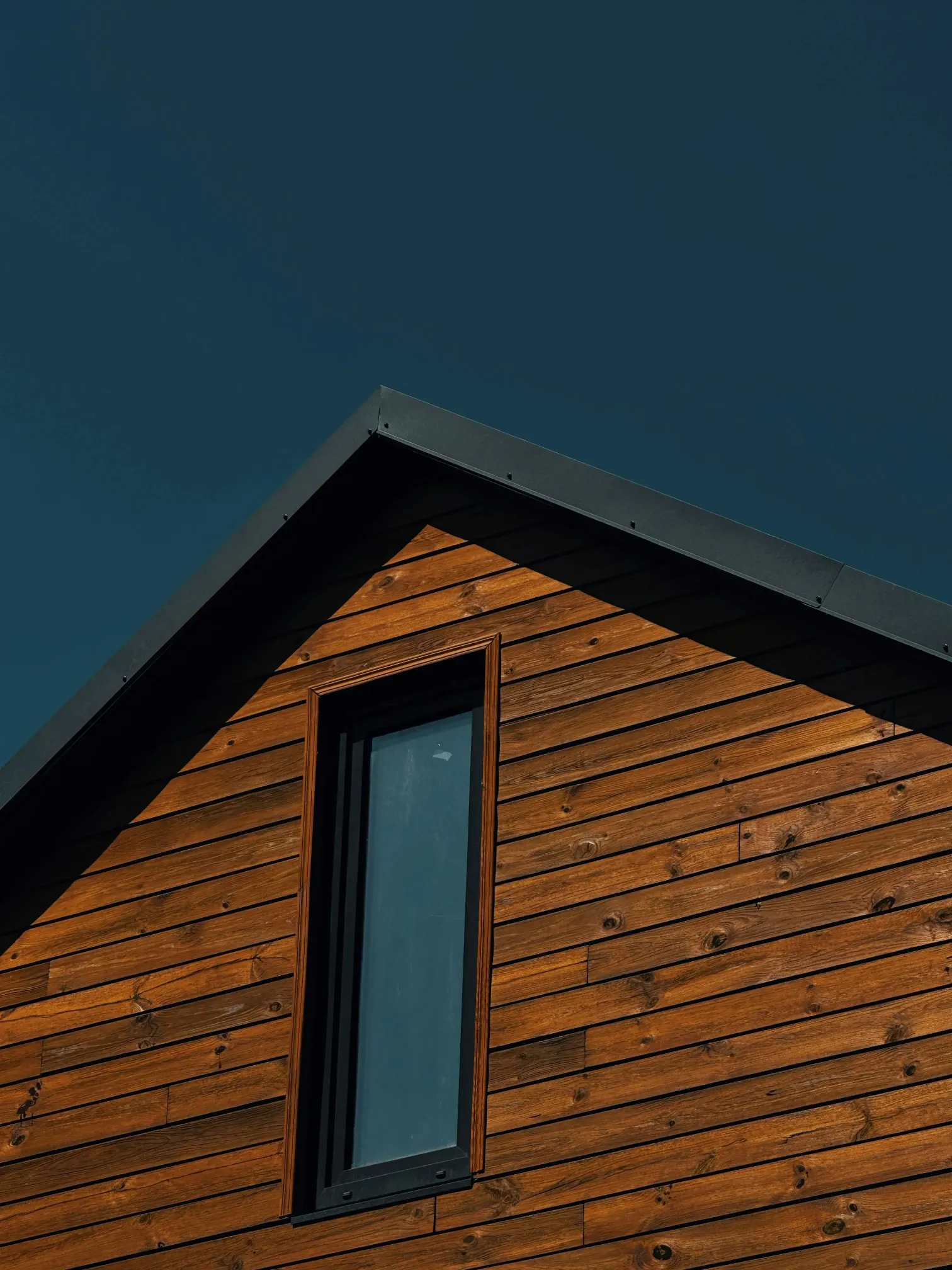 Wooden house facade with a dark sky