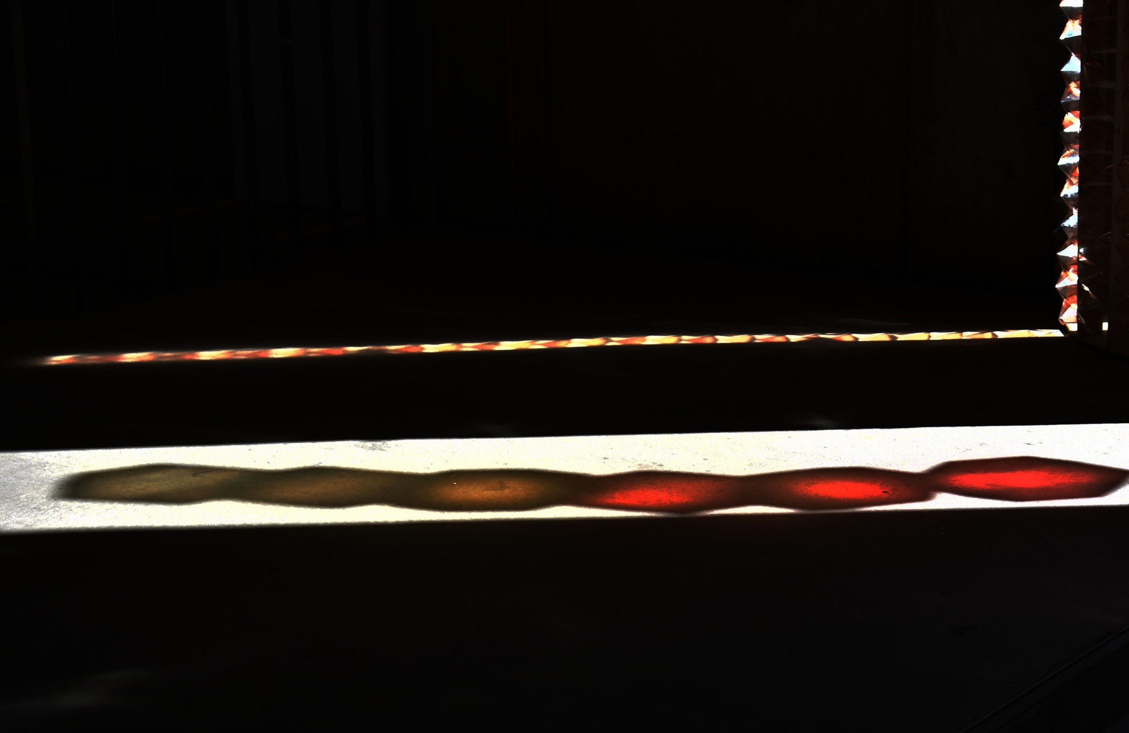 Coloured daylight and shadows across the floor.