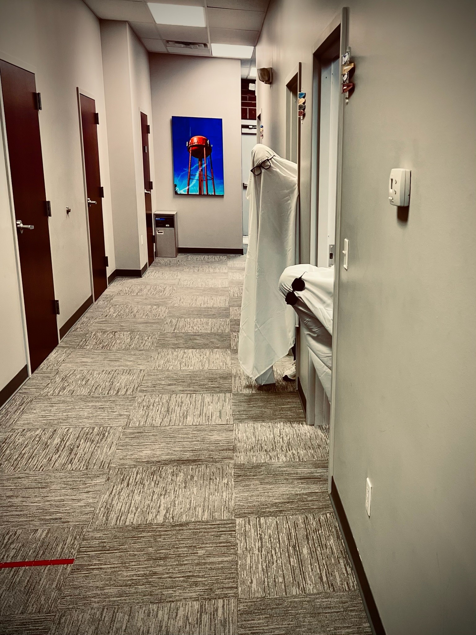 Interior hallway of OSMC Orthopedic and Sports Medicine Center featuring local St. Joseph Missouri water tower artwork and patient exam rooms