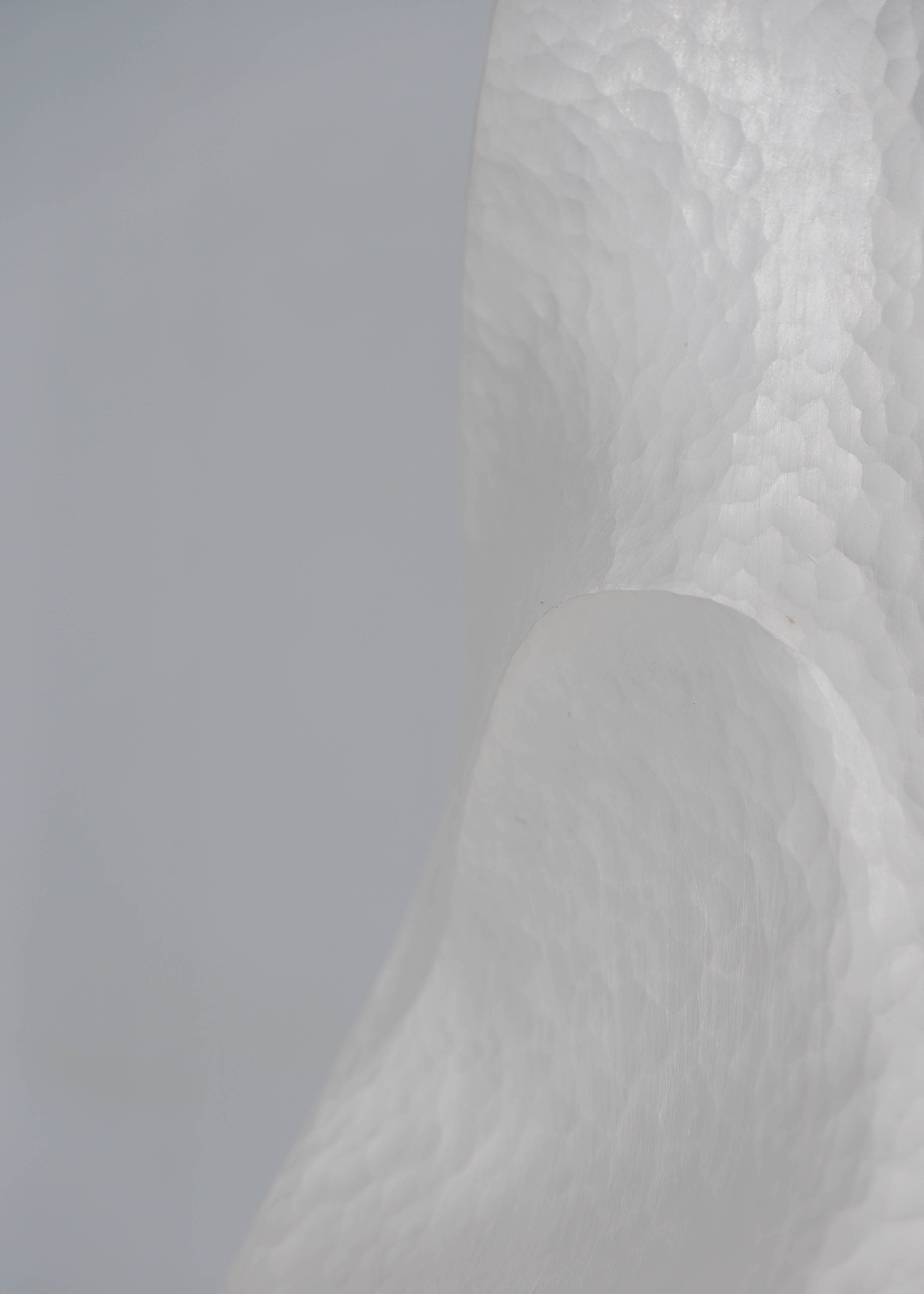 Close-up of Constrict by Yuxin Song, hand-forged fine silver vase. Contemporary silversmithing and metalwork by artist Yuxin Song