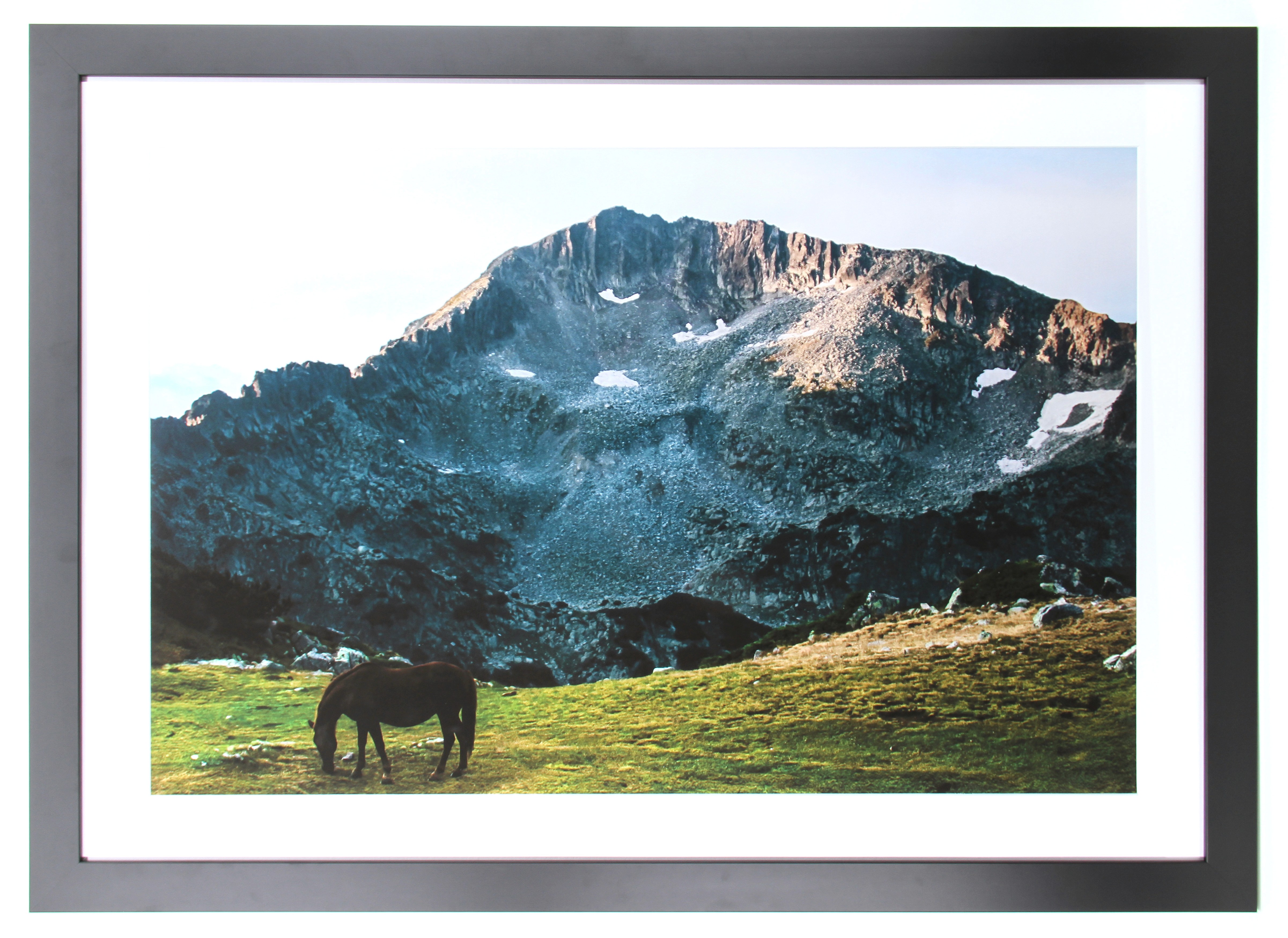 Modern bathroom featuring wooden cabinetry, a bathtub, a sleek sink, and natural light from a window.
