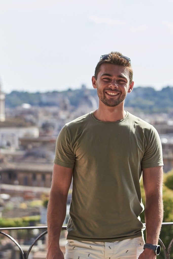Black and white portrait of a smiling person with curly hair