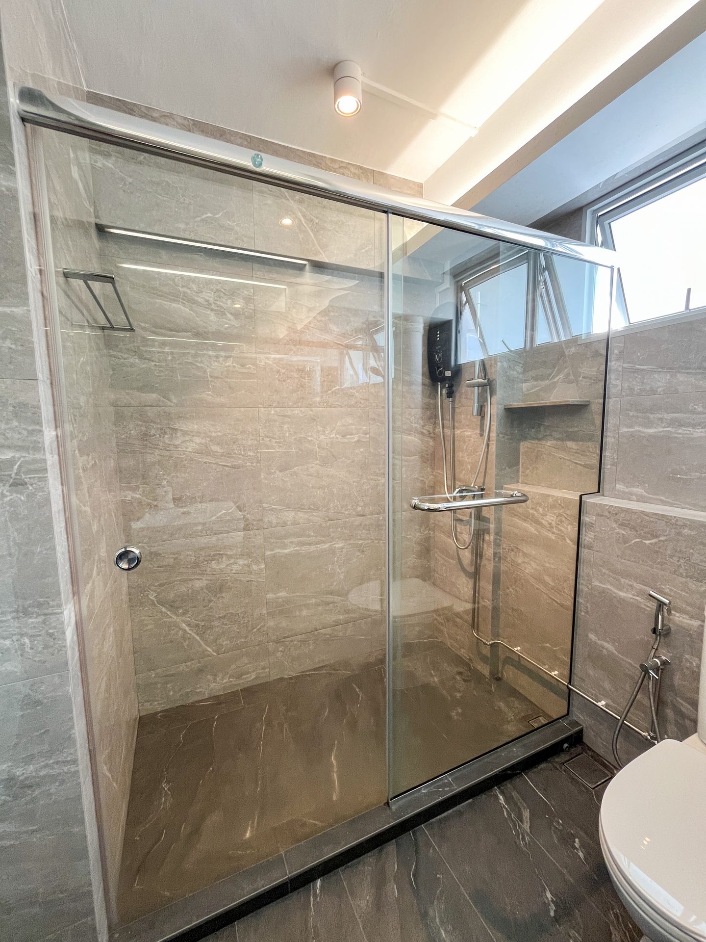 Dark grey non slip floor tiles set against glossy light grey wall tiles from Hafary