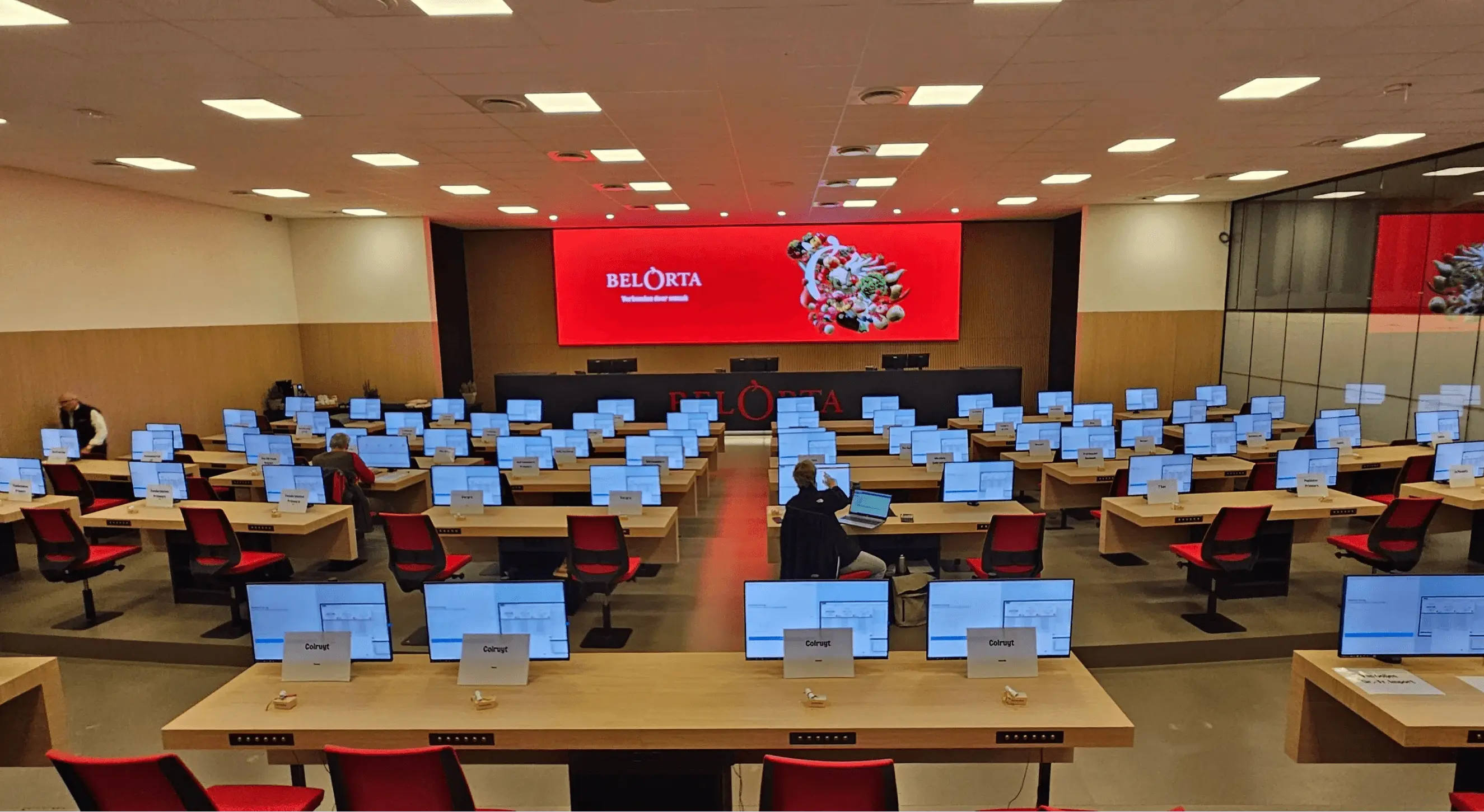 big auction hall with screens