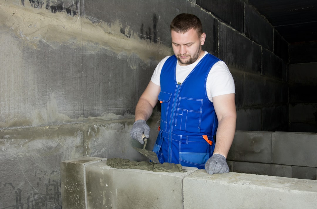 a man in a hard hat working on a piece of metal