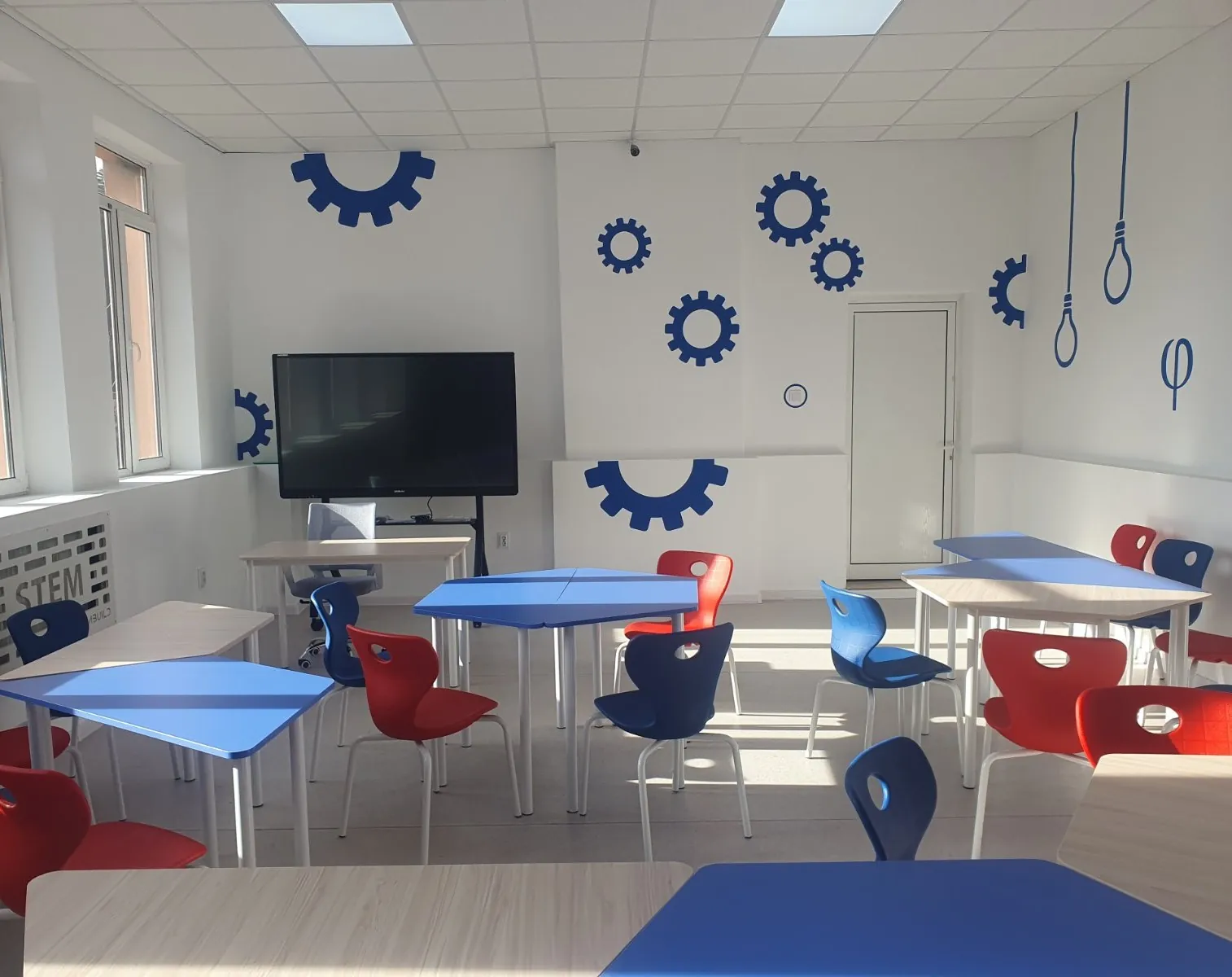Modern classroom with colorful school chairs and tables
