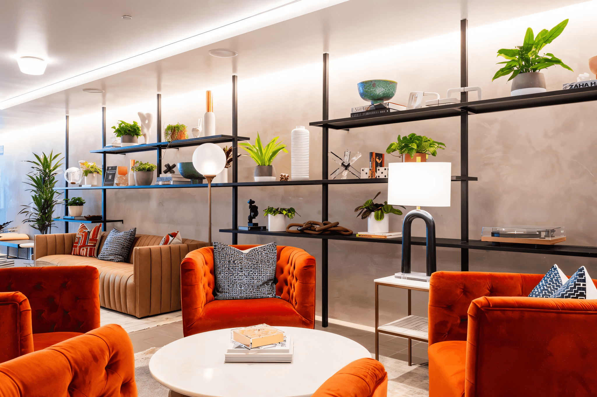 A living room at Ventana Residences featuring green furniture and a round table, creating a cozy and inviting atmosphere.